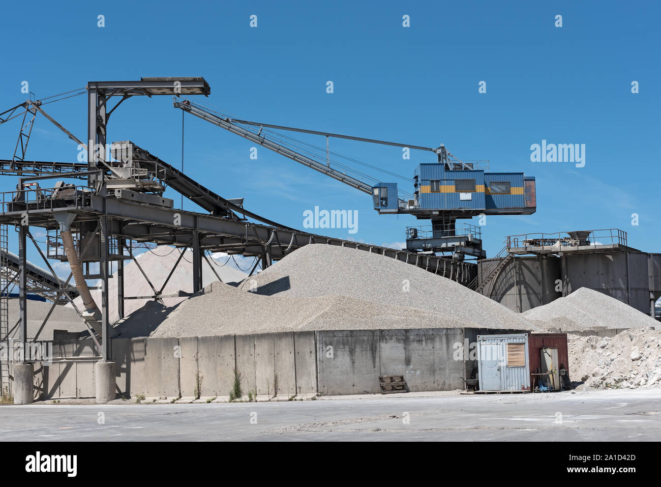 Une grue avec du gravier dans une gravière et différents types de pierre Banque D'Images