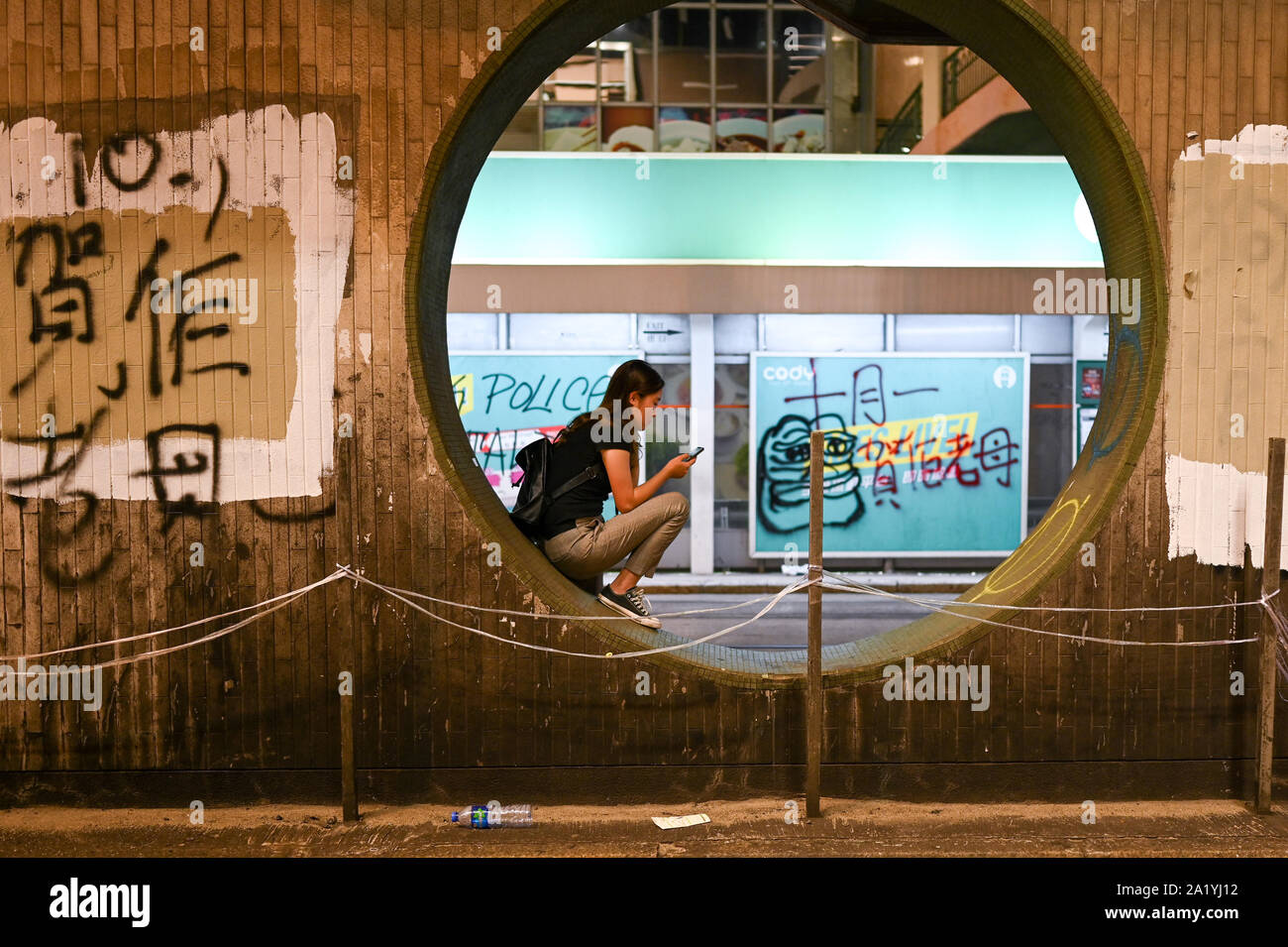 Hong Kong, Hong Kong. Sep 29, 2019. Une fille est assise sous un passage supérieur au cours d'un meeting de protestation qui ont tourné à la violence à Hong Kong le 29 septembre 2019. Photo de Thomas Maresca/UPI UPI : Crédit/Alamy Live News Banque D'Images