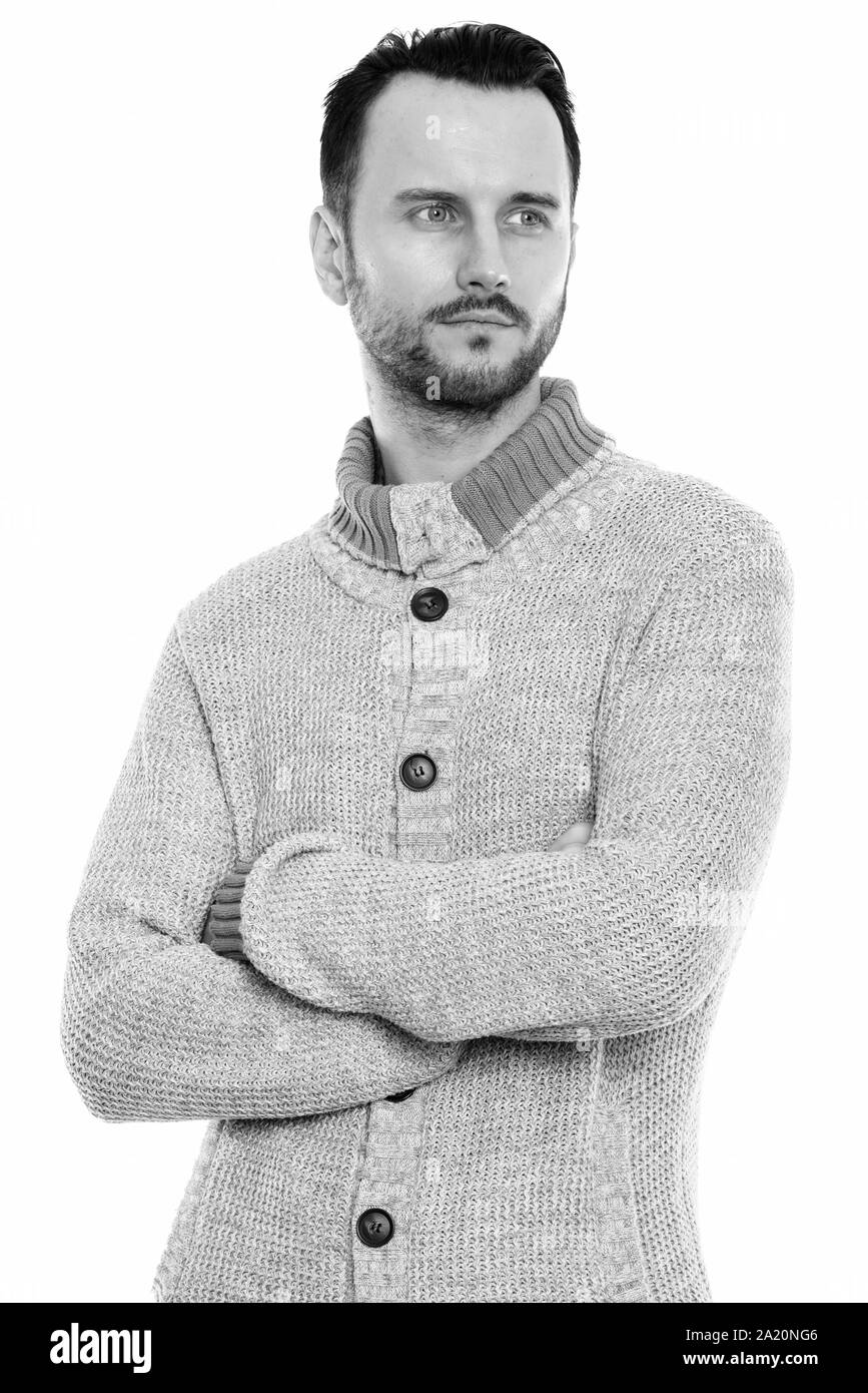 Portrait of young man thinking with arms crossed Banque D'Images