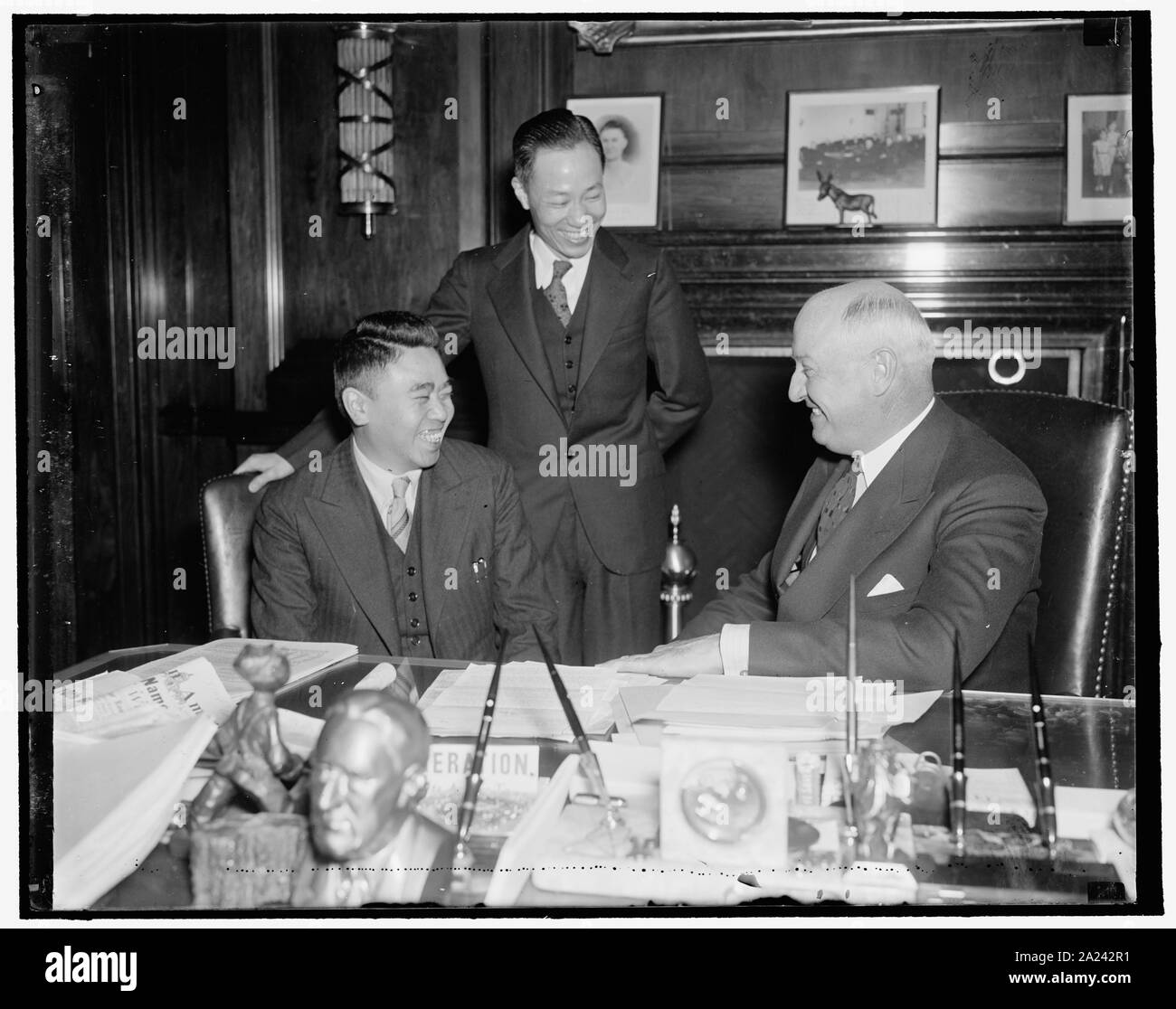 PMG Farley reçoit de Chine Bureau de poste officiel de la Confédération. Washington, D.C., le 14 avril. PMG Farley disait probablement sur sa campagne de stock de blagues pour Chi Hsueh Ventilateur, fonctionnaire de l'Office National Post Confédération de Chine, comme cette photo a été prise. Farley a reçu les deux aujourd'hui avec Pei Yuan Ho (debout), premier secrétaire de l'ambassade de Chine, 4/14/1937 Banque D'Images