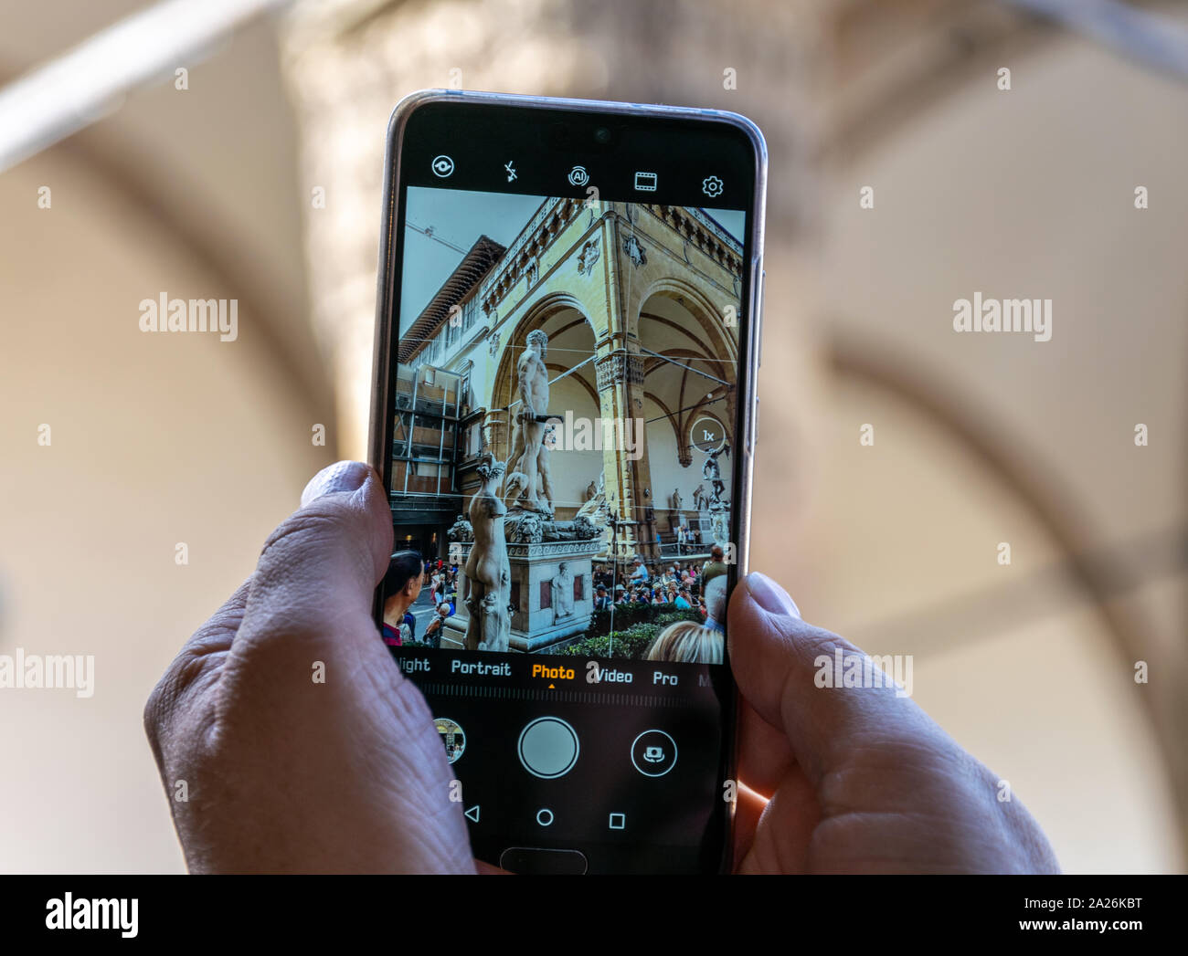 Un écran de téléphone mobile avec le photographe de prendre une photo de la statue de Baccio Bandinelli's Hercules dans la Piazza della Signoria, Florence, Italie Banque D'Images