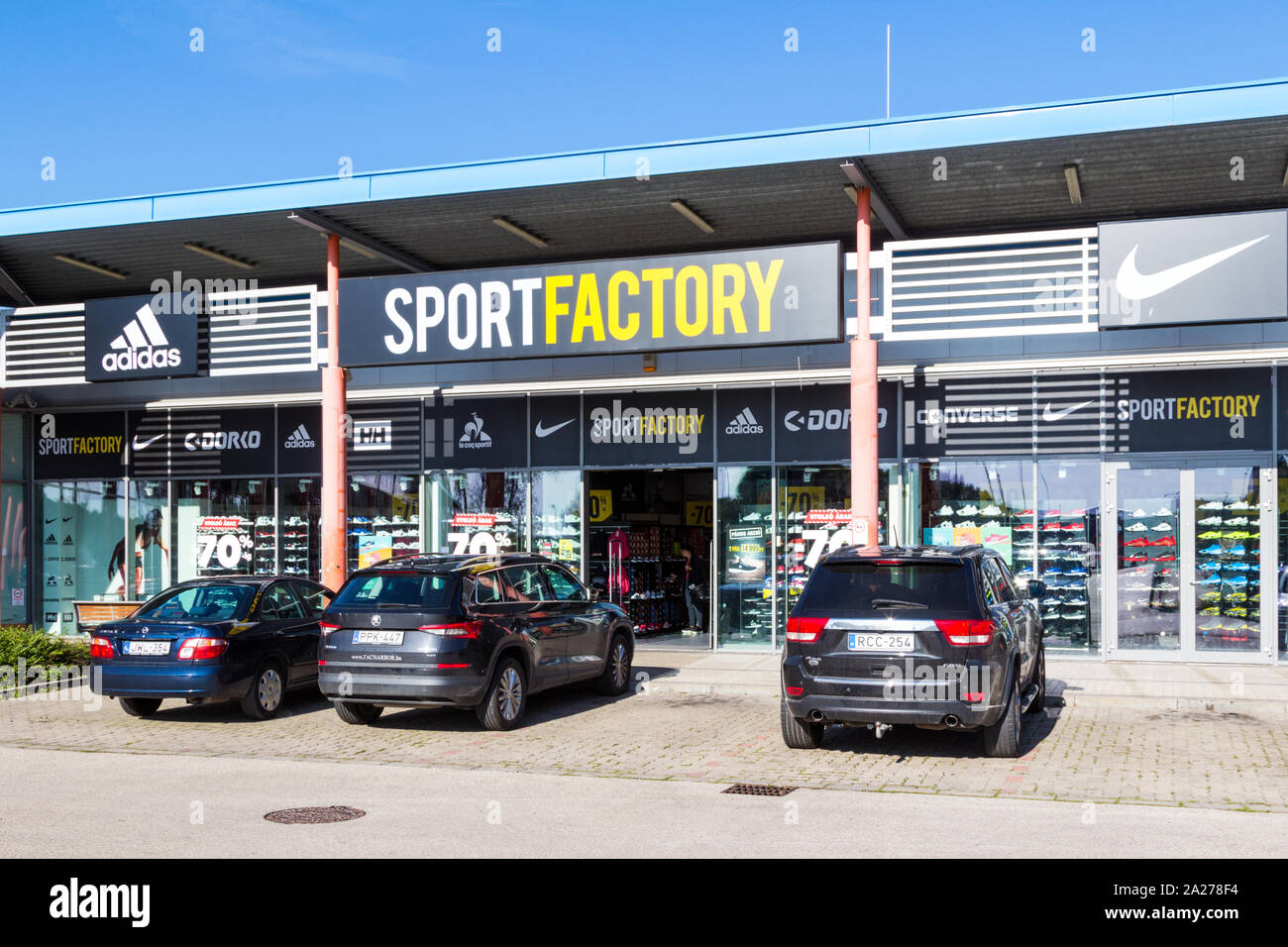 Sportfactory et sport sports clothes shop store façade avant avec grand logo marque Nike et Adidas dans familiale, Sopron, Hongrie Banque D'Images