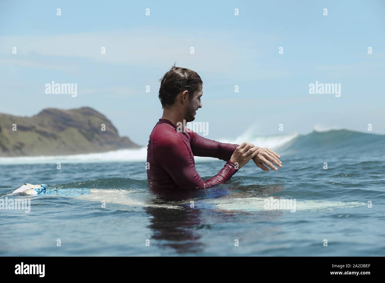 Smiling man on surfboard sur l Banque D'Images