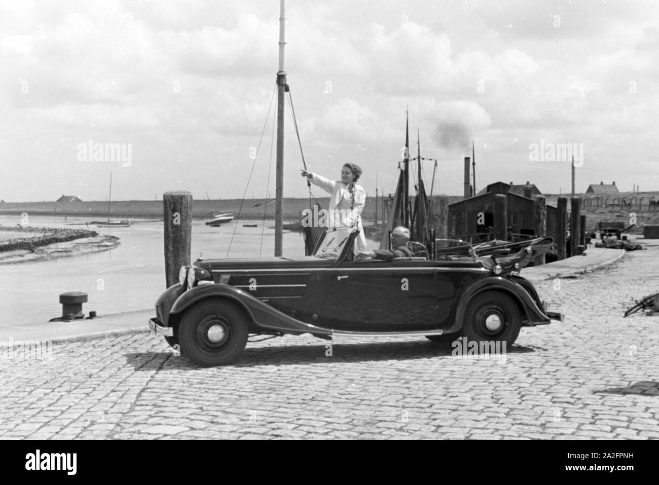 Eine Frau und ein Mann in einem Audi Cabrio dans les années 1930, Deutschland Norddeich er Jahre. Une femme et un homme dans une Audi Convertible à Norden, Allemagne 1930. Banque D'Images