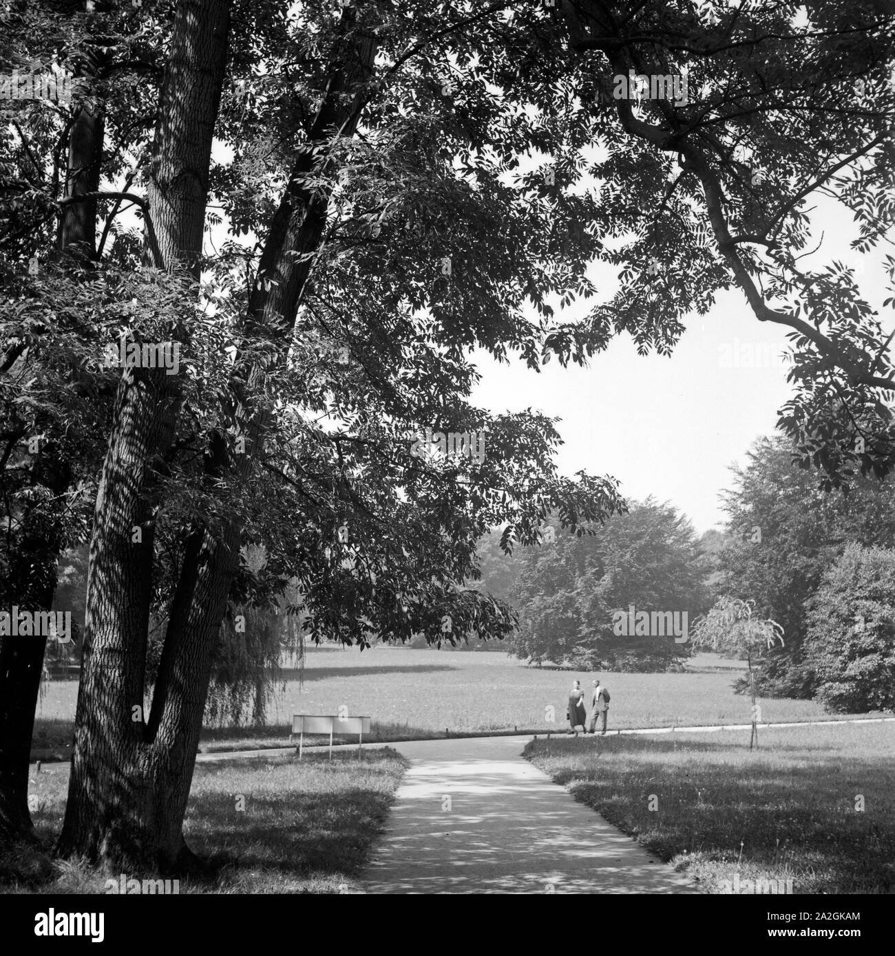 Ein Paar spaziert durch den von Kurpark de Bad Homburg, Deutschland 1930 er Jahre. Un couple se promenant dans les jardins de la station thermale de Bad Homburg, Allemagne 1930. Banque D'Images