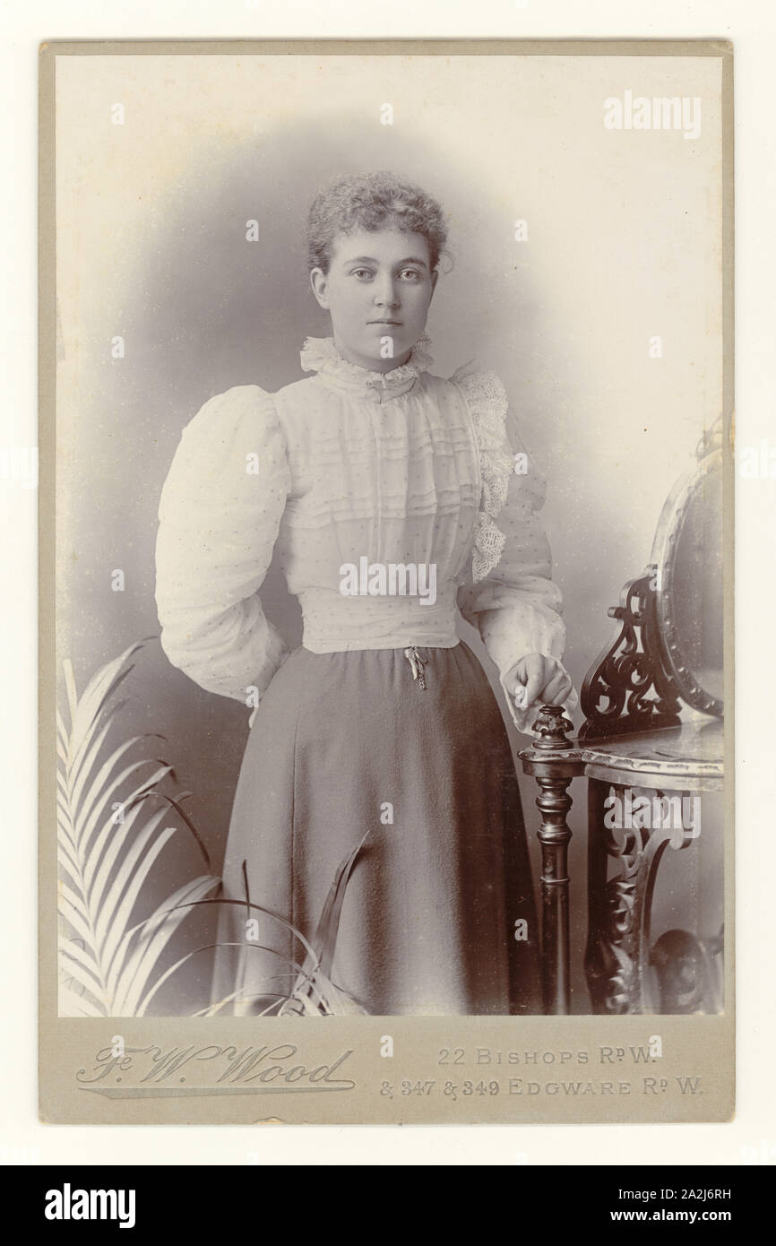 Carte victorienne représentant une belle jeune femme, portant un chemisier en dentelle à col haut à manches complètes, studio de F. W. Wood d'Elliott et Fry, West London, Royaume-Uni vers 1898 1899 Banque D'Images