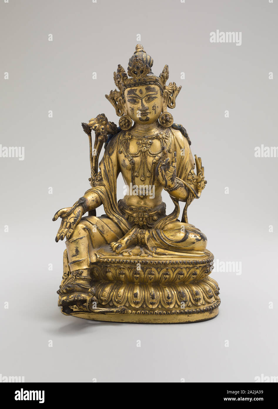 Tara verte, assis en posture de la Facilité (Lalitasana), avec des tiges de lotus sur l'épaule droite et les mains dans les gestes de raisonnement (Vitarkamudra) et cadeau attributive (Varadamudra), dynastie Ming (1368-1644), règne Yongle marque et période (1403-24), de la Chine, de l'alliage de cuivre doré avec traces de pigment (lapis-lazuli), 21,5 × 13,5 × 12,5 cm (8 1/2 x 5 1/4 x 4 7/8 po Banque D'Images