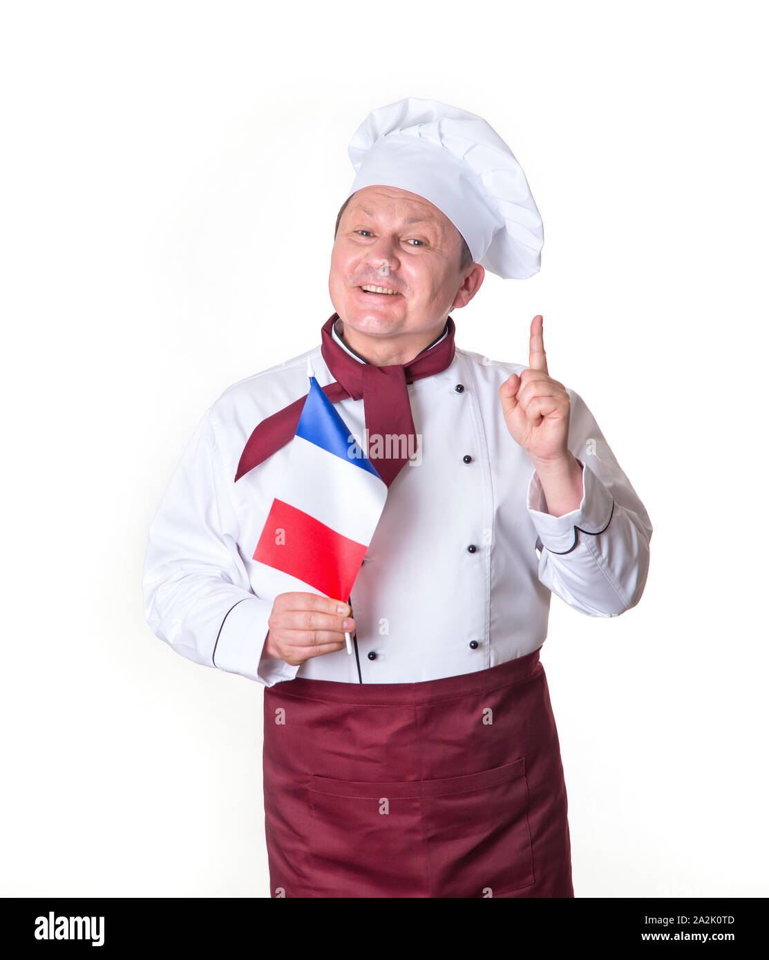 Chef avec un drapeau de la France sur un fond clair. Homme d'âge moyen. Portrait happy cook montrant doigt vers le haut. Bonne idée. Banque D'Images