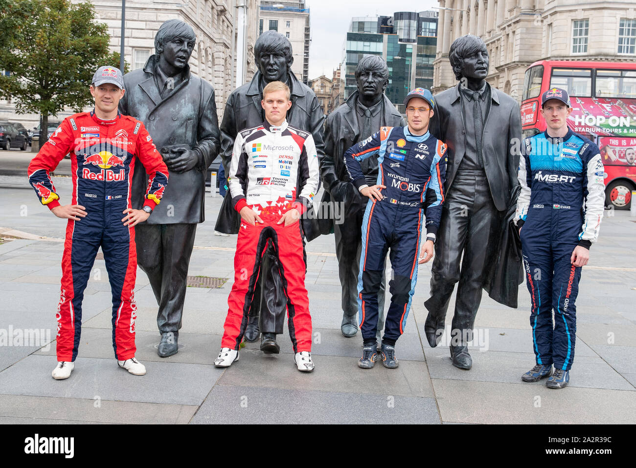 Liverpool, Royaume-Uni. 3e oct, 2019. (L), Sébastien Ogier, Ott Tänak, Thierry Neuville & Elfyn Evans poser pour des photos en face de la populaire, des statues en bronze des quatre Beatles créé par le sculpteur Andy Edwards au Pier Head, avant le début de la Wales Rally GB, Crédit : Jason Richardson/Alamy Live News Banque D'Images