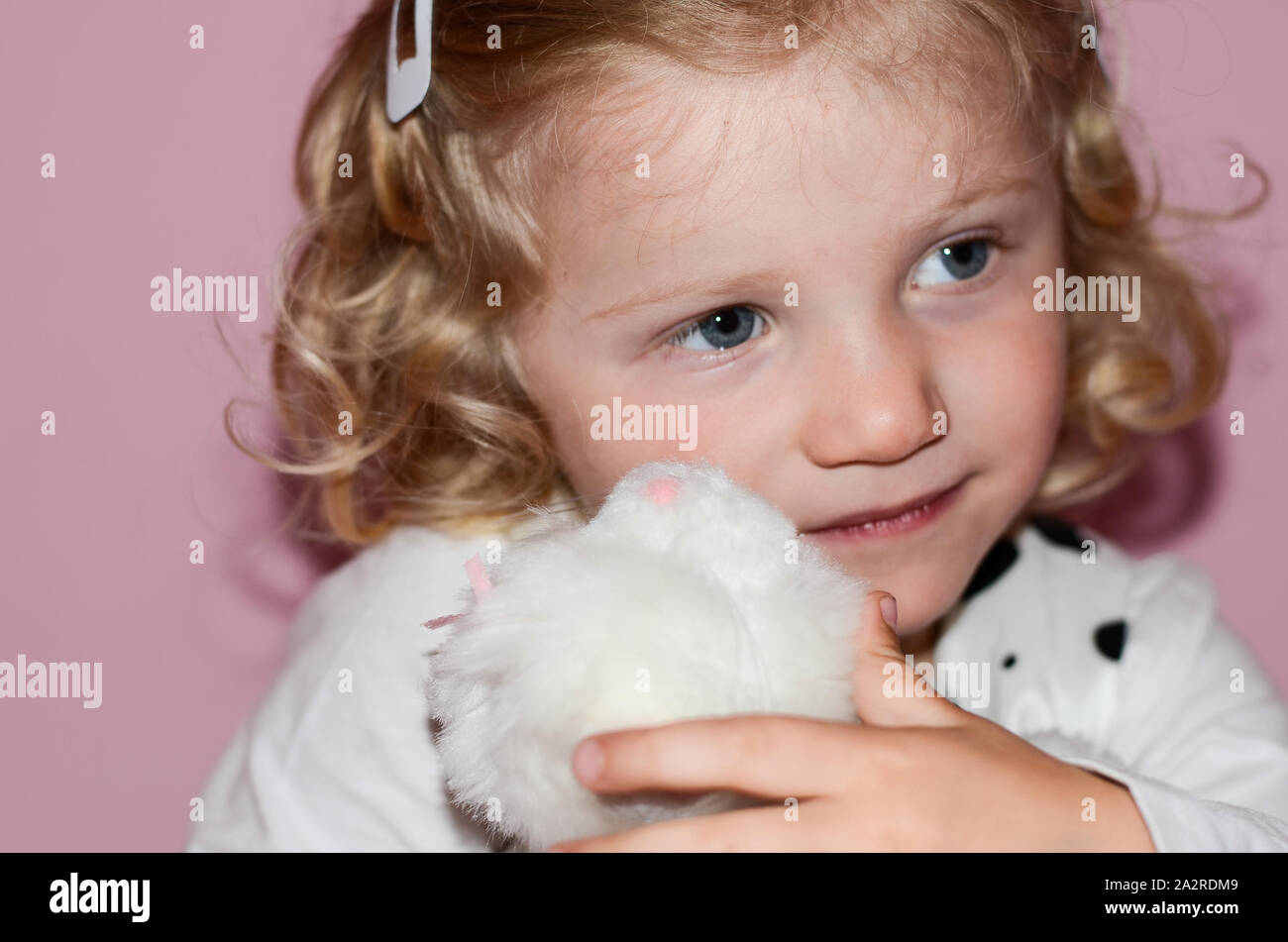 Blonde girl holding a toy Banque D'Images