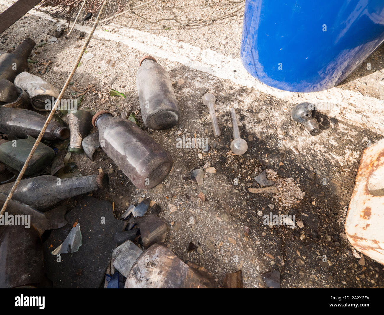 Un gros plan de bouteilles et les pipes à crack laissés sur le terrain. Banque D'Images