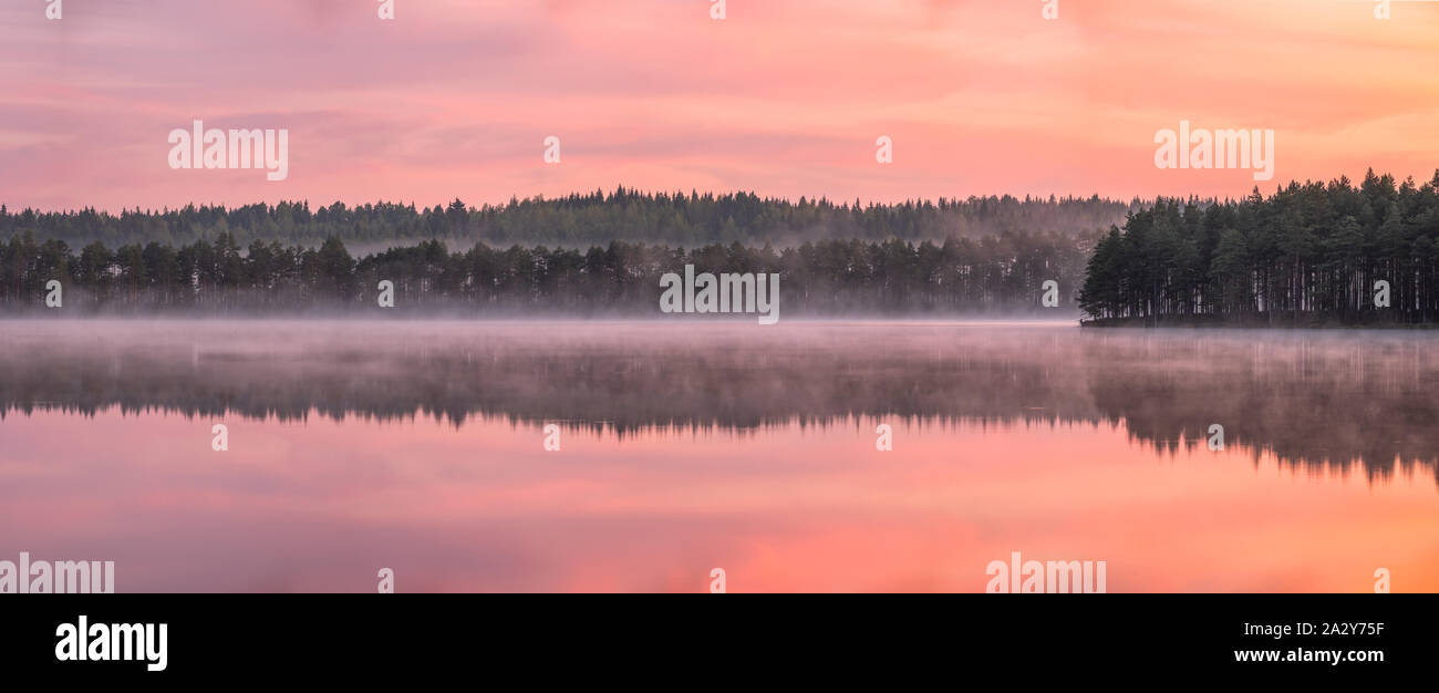 Beau lever de soleil paysage avec calme et d'humeur Misty Lake à foggy matin d'été en Finlande Banque D'Images
