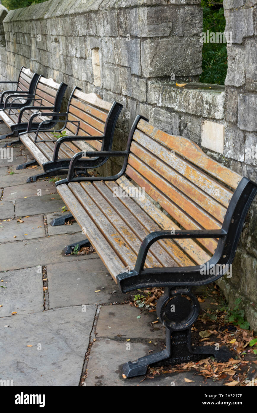 bancs de jardin en bois et en fer à côté des murs de la ville dans le centre-ville de york, yorkshire, royaume-uni Banque D'Images