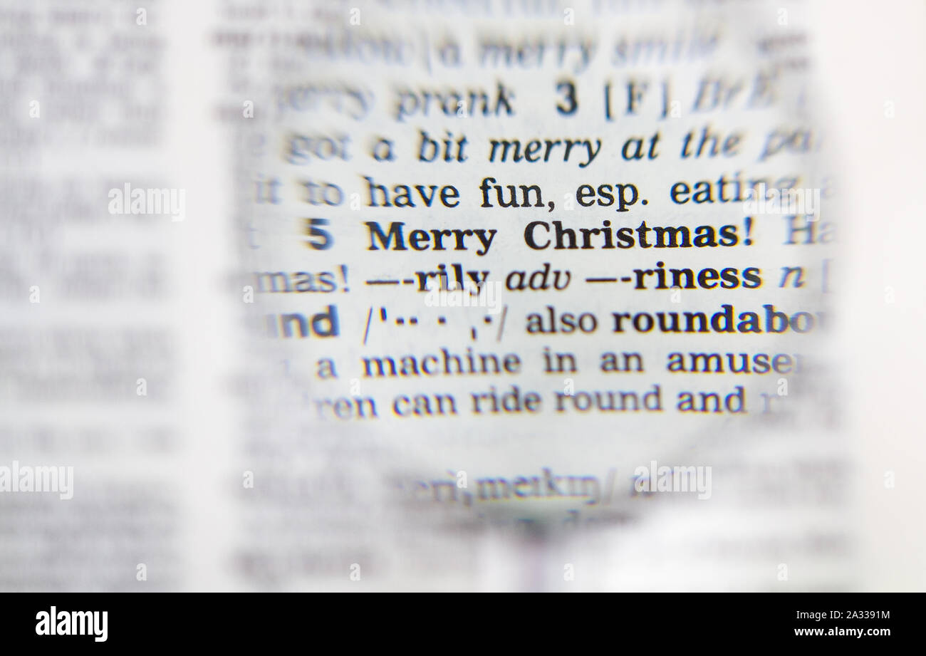 Le mot joyeux Noël définition dans le dictionnaire vieux sous la loupe Banque D'Images