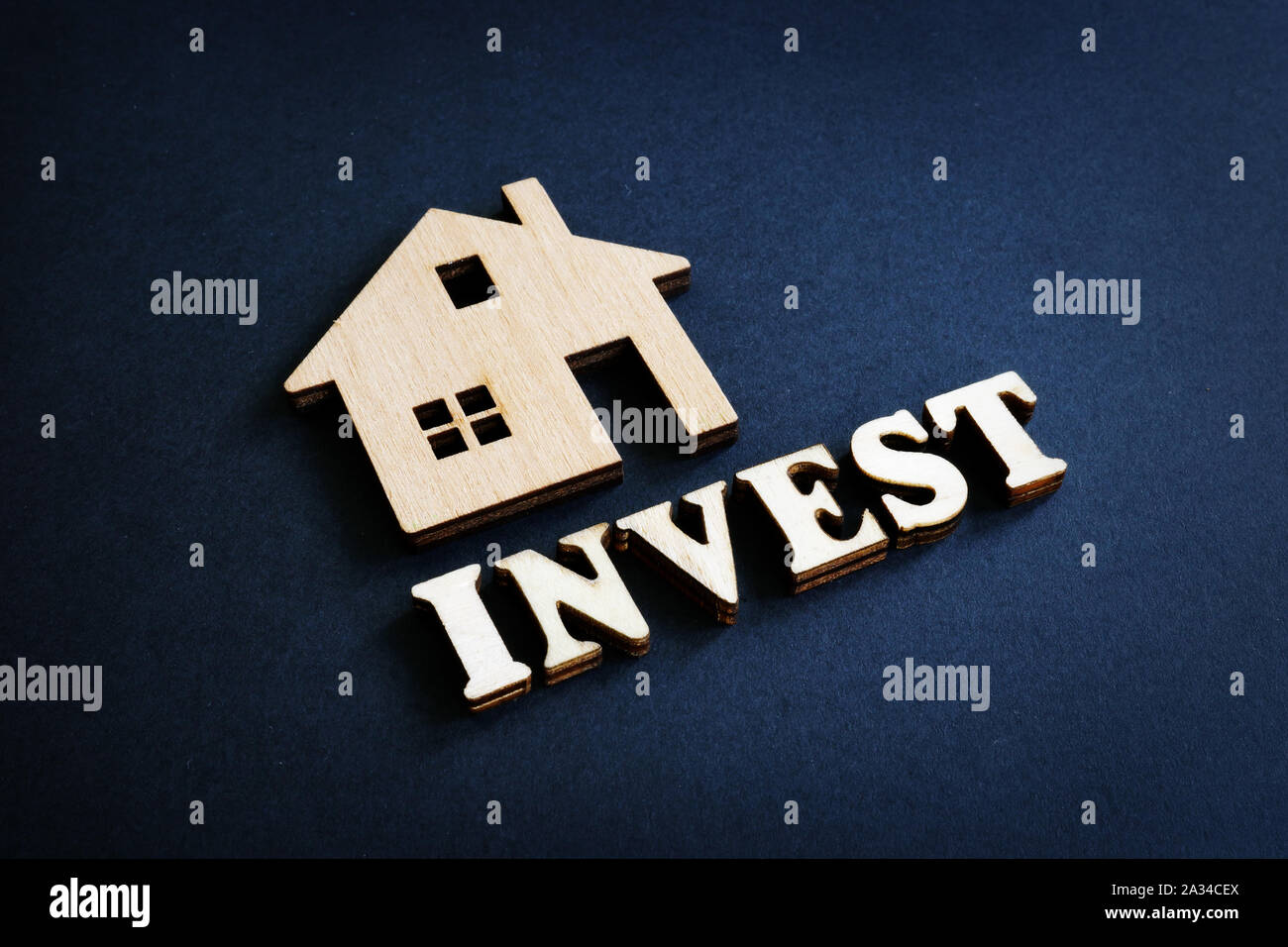 Mot investir et le modèle de la maison à partir de bois. Concept d'investissement immobilier. Banque D'Images