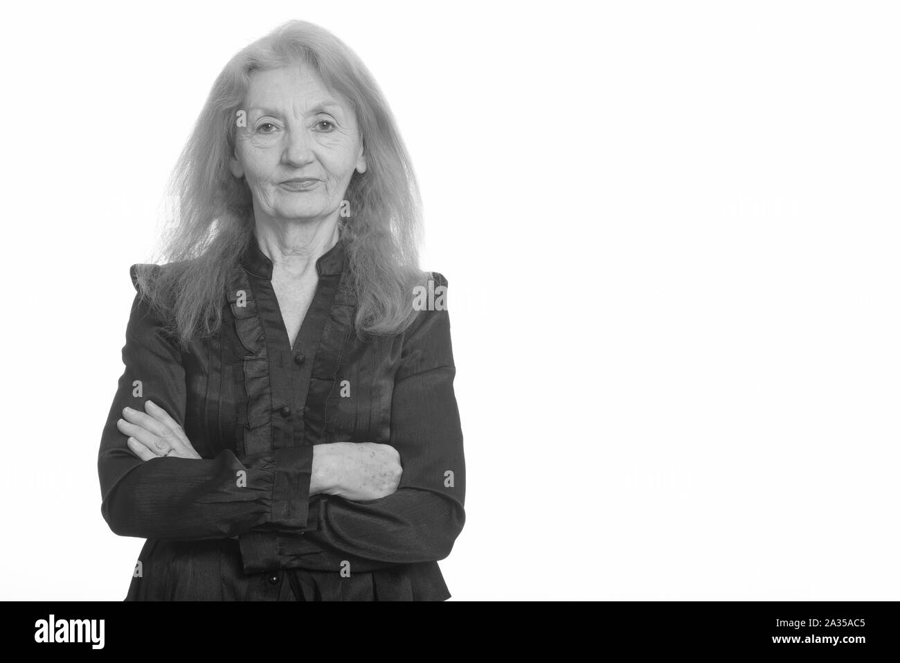 Studio shot of senior businesswoman with arms crossed Banque D'Images