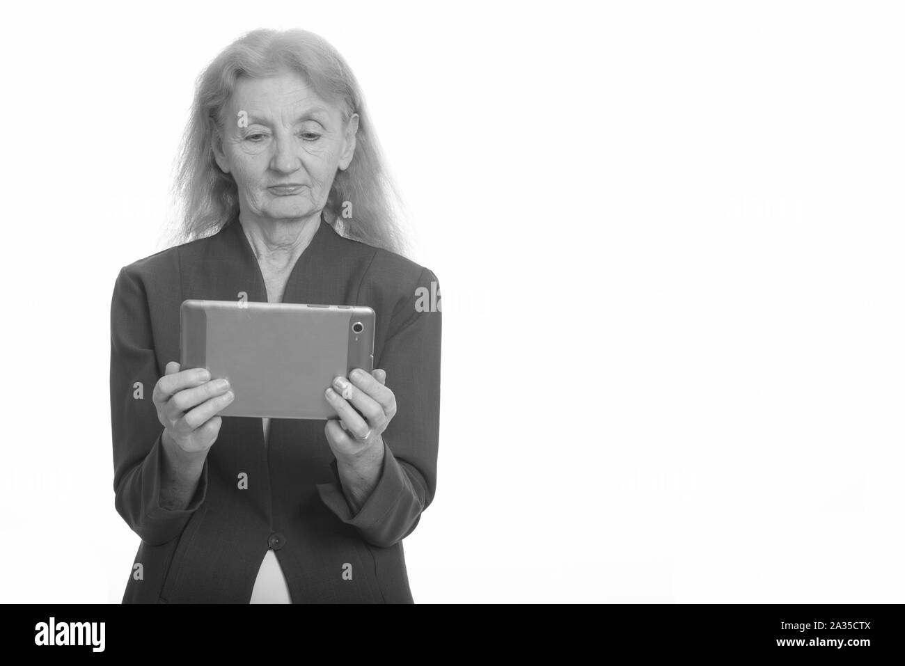 Studio shot of senior businesswoman using digital tablet Banque D'Images