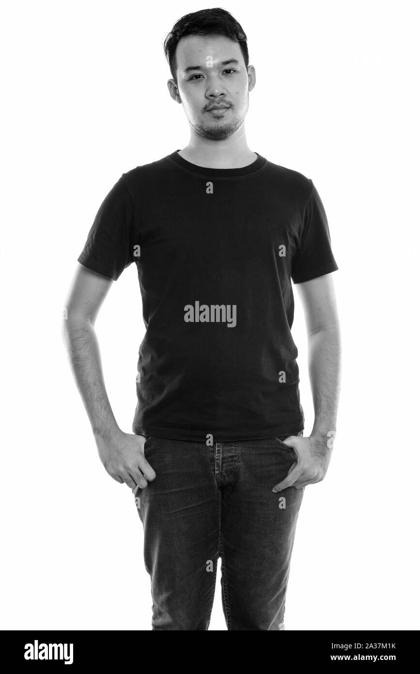 Studio shot of young Asian man standing Banque D'Images Studio shot of young Asian man standing Banque D'Images