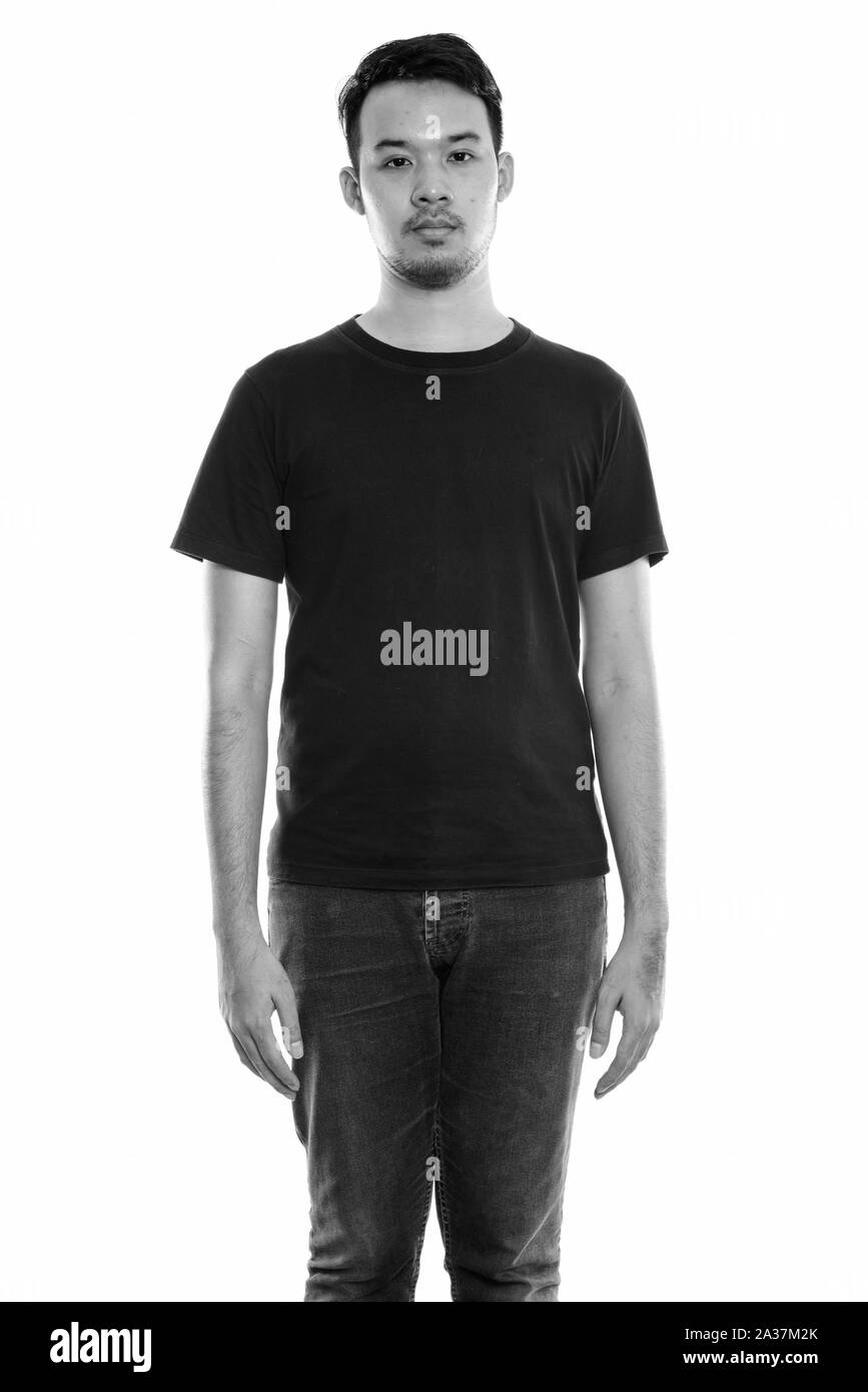 Studio shot of young Asian man standing Banque D'Images Studio shot of young Asian man standing Banque D'Images