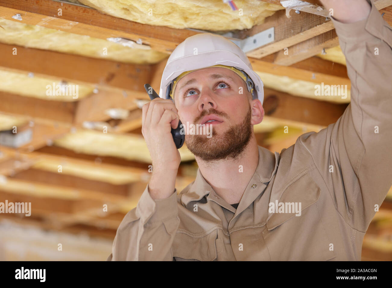 Homme builder in hardhat avec talkie walkie Banque D'Images