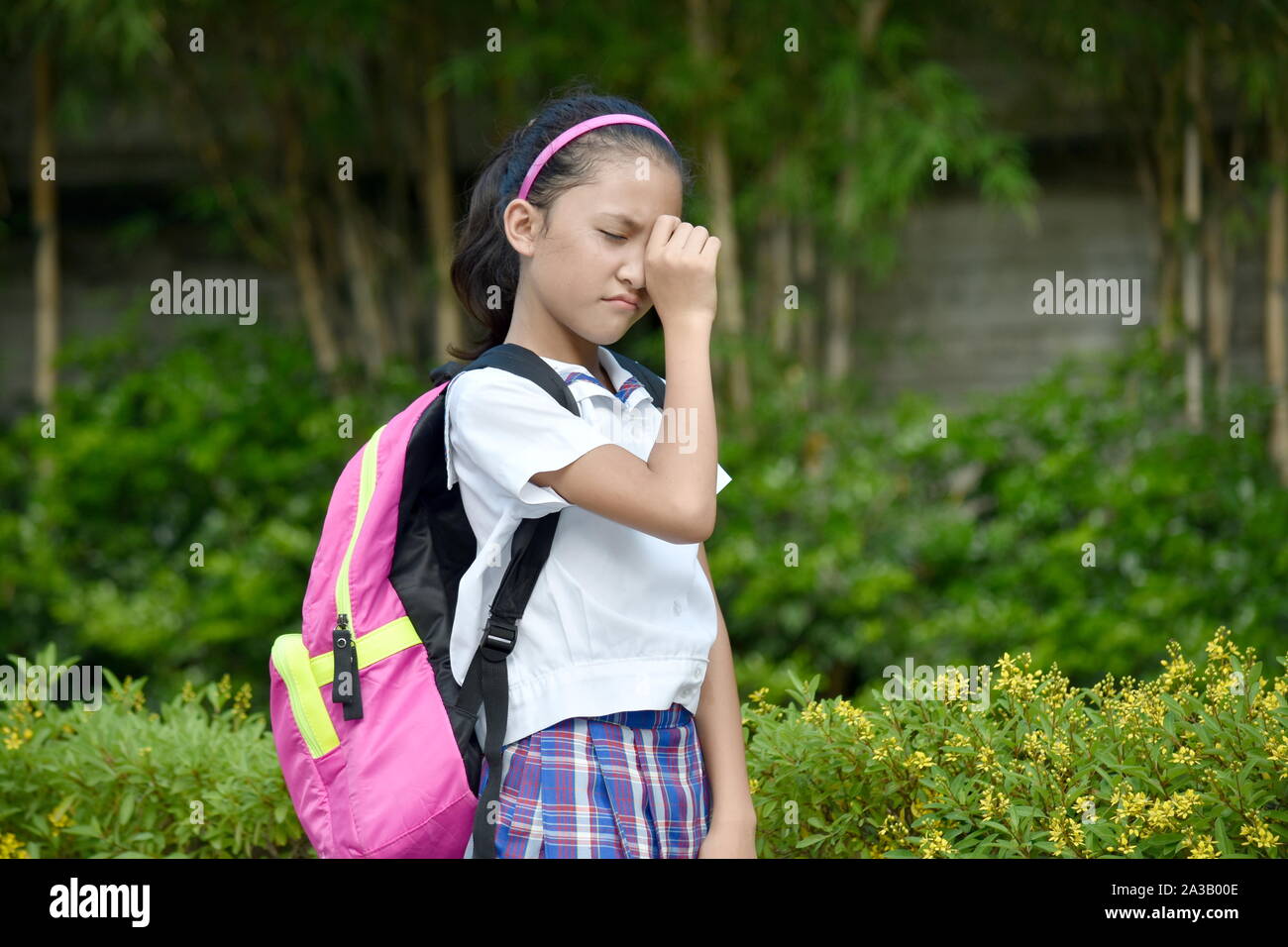 Une fille de l'école en larmes portant l'uniforme scolaire Banque D'Images