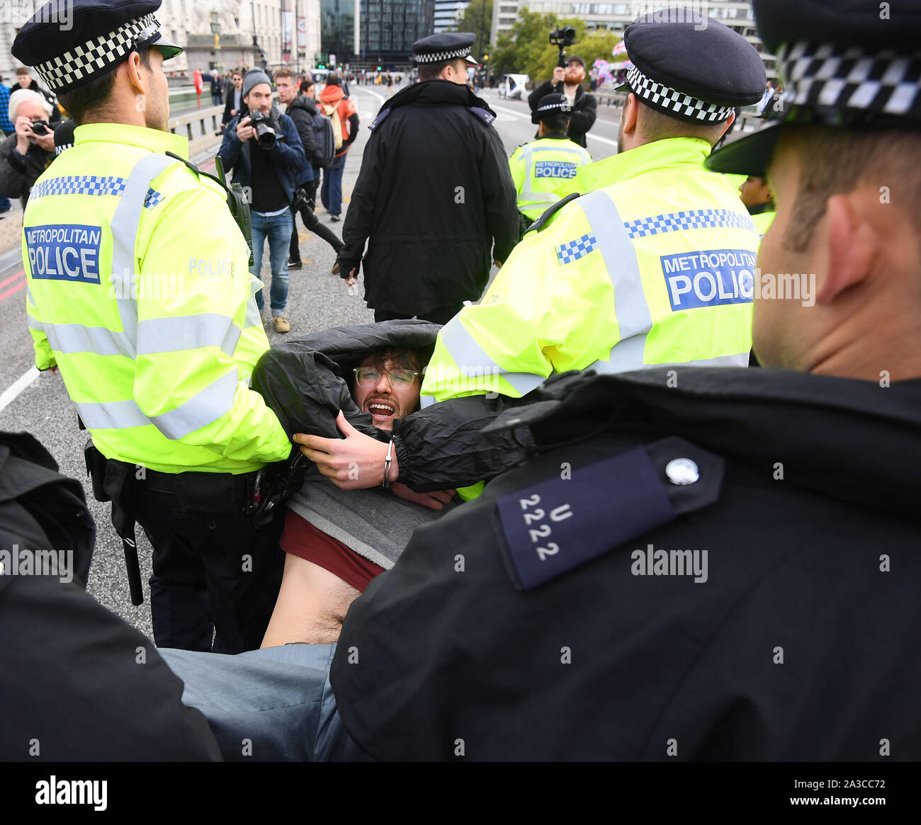 Un manifestant d'être arrêtés sur le pont de Westminster, au cours d'une rébellion d'Extinction (XR) Manifestation à Westminster, Londres. Banque D'Images