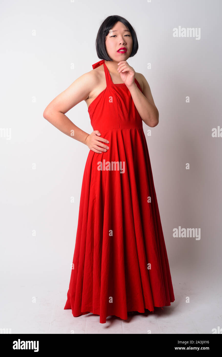 Full body shot of young gay Asian man thinking Banque D'Images