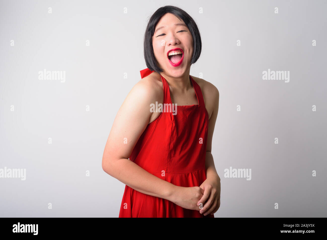 Portrait of happy young gay Asian man laughing Banque D'Images