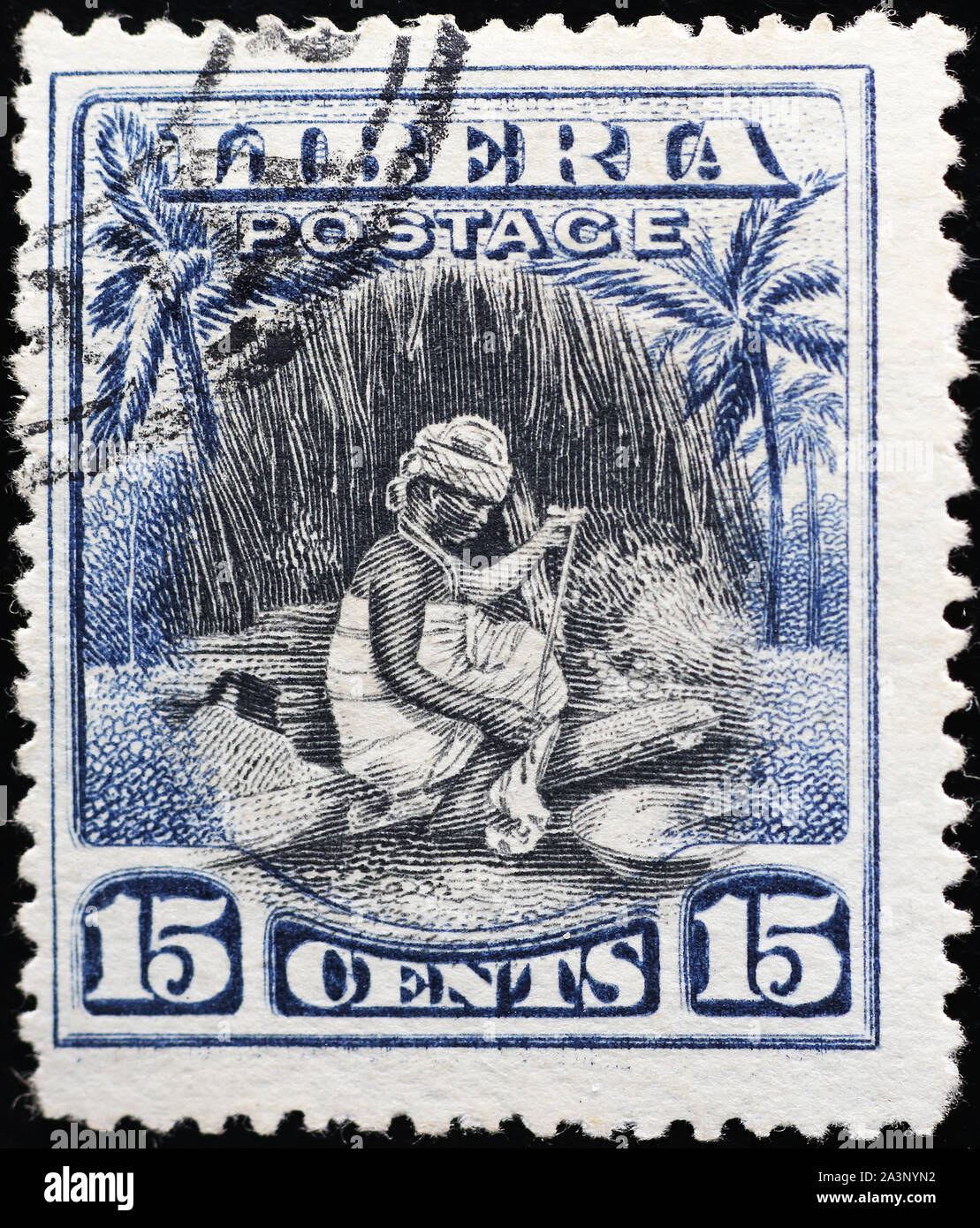 Femme au travail sur les vieux stamp du Libéria Banque D'Images