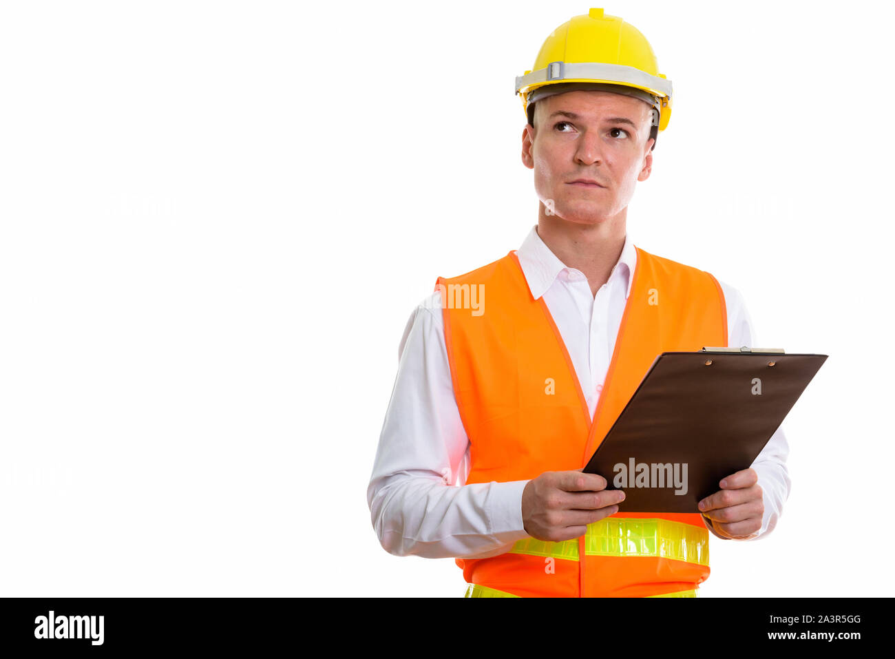 Studio shot of young handsome man construction worker holding cl Banque D'Images