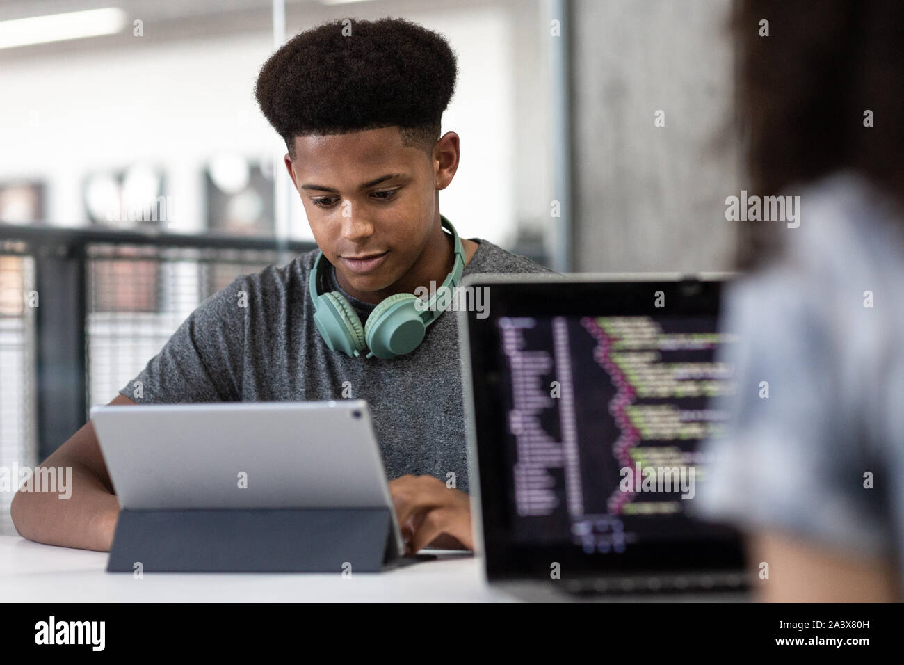 African American male student coding in class Banque D'Images