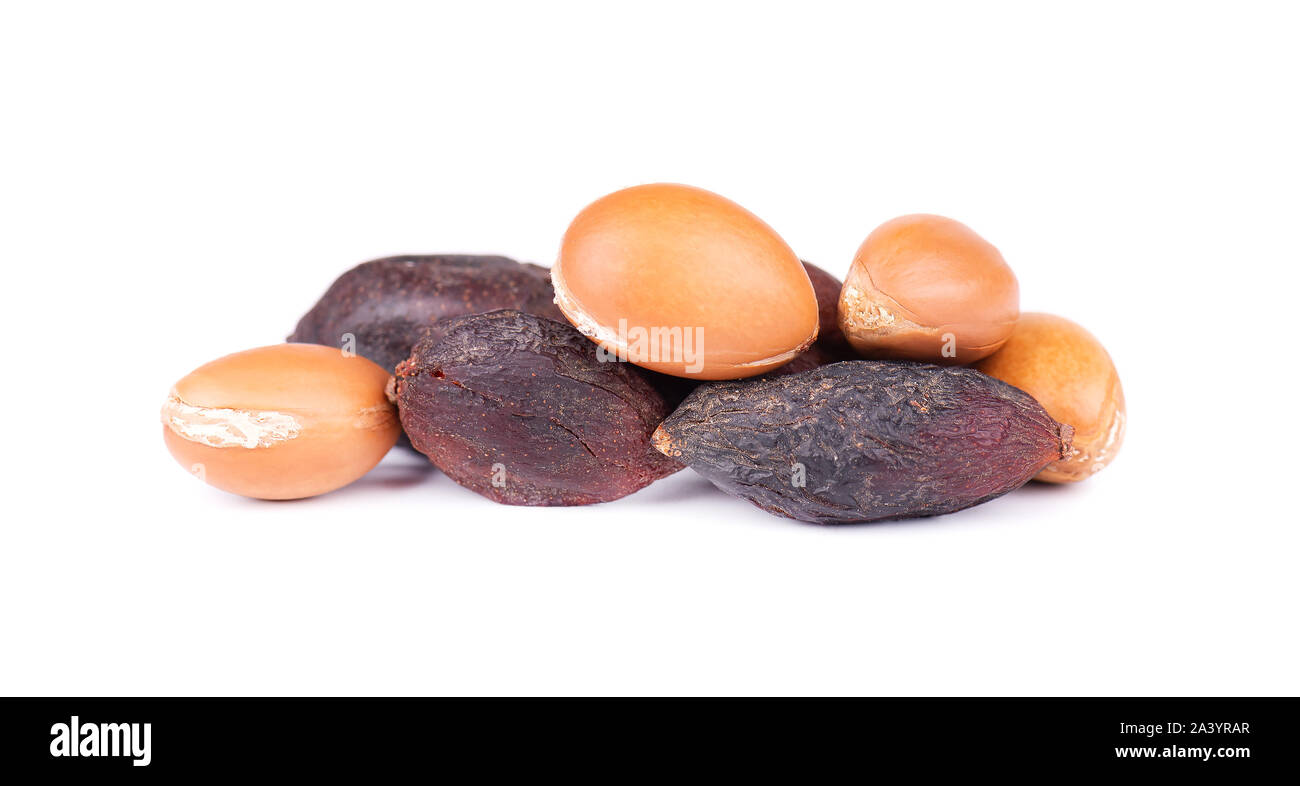 Graines d'Argan, isolé sur un fond blanc. Les noix et l'huile d'Argan cosmétique, et de produits de beauté. Fruit naturel du Maroc. Banque D'Images