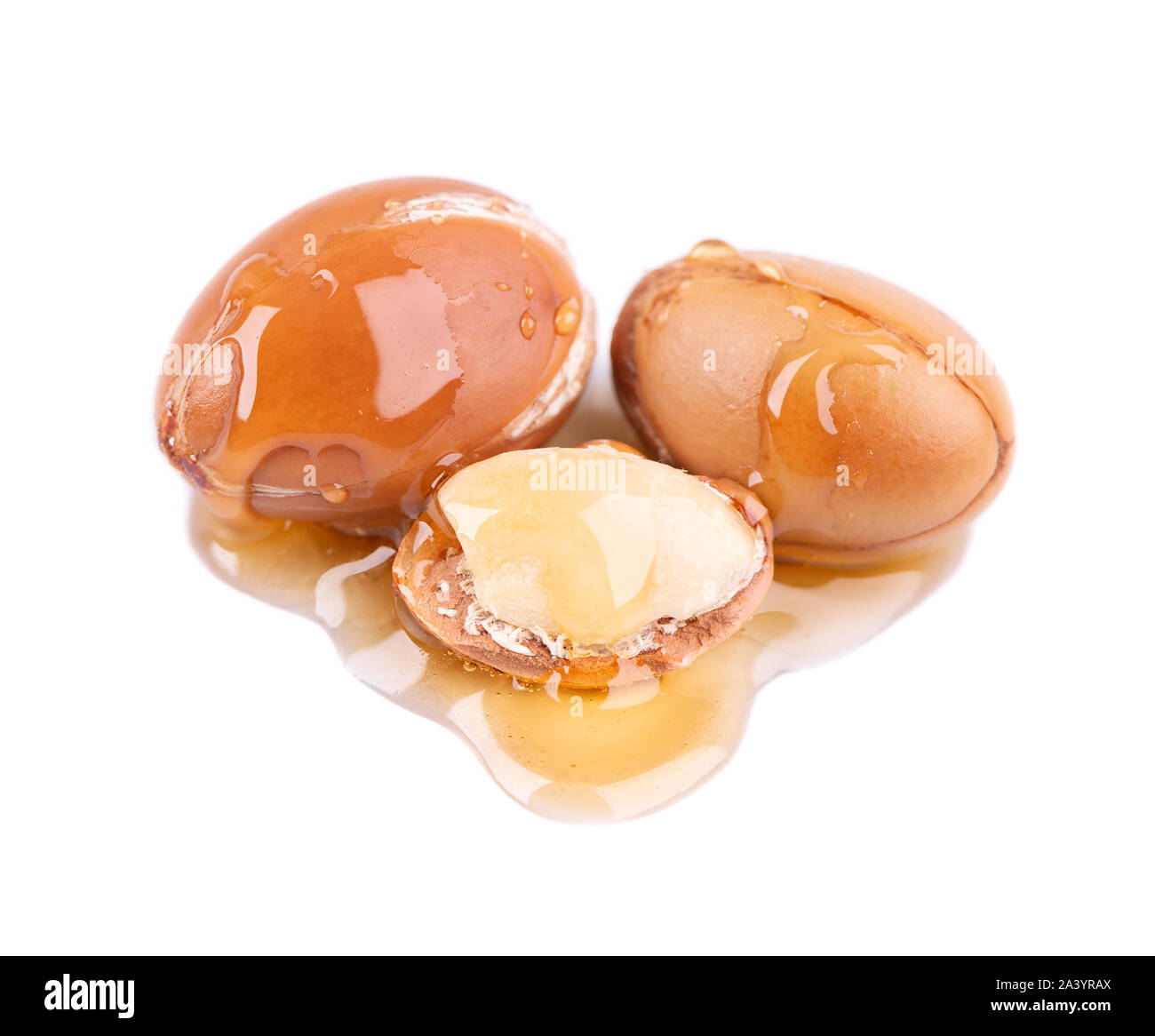 Graines d'Argan, isolé sur un fond blanc. Les noix et l'huile d'Argan cosmétique, et de produits de beauté. Fruit naturel du Maroc. Banque D'Images