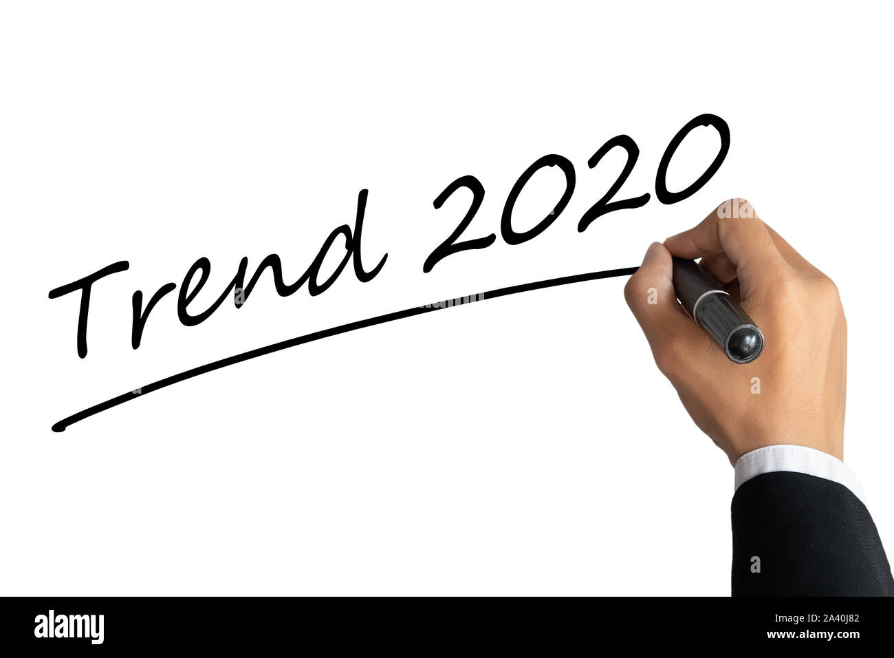 L'homme d'affaires part écrit mot tendance 2020 couleur noir avec stylo marqueur isolé sur fond blanc.TENDANCES 2020 Concept d'affaires Banque D'Images