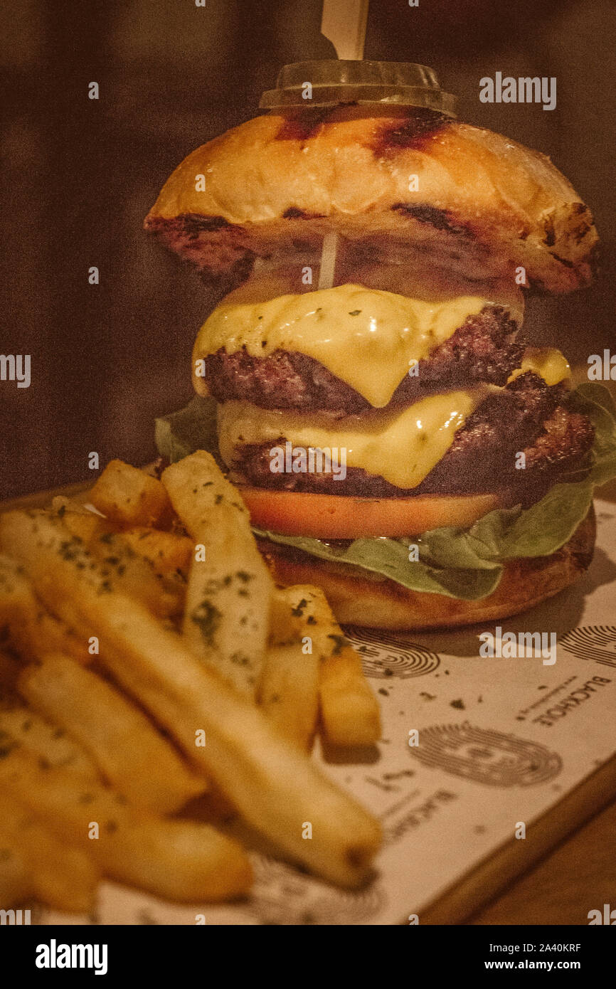 130 du boeuf gm patty, tomates, laitue romaine, le cheddar doux, l'aneth, des chips, de la relish tomate mayonnaise relish. Banque D'Images