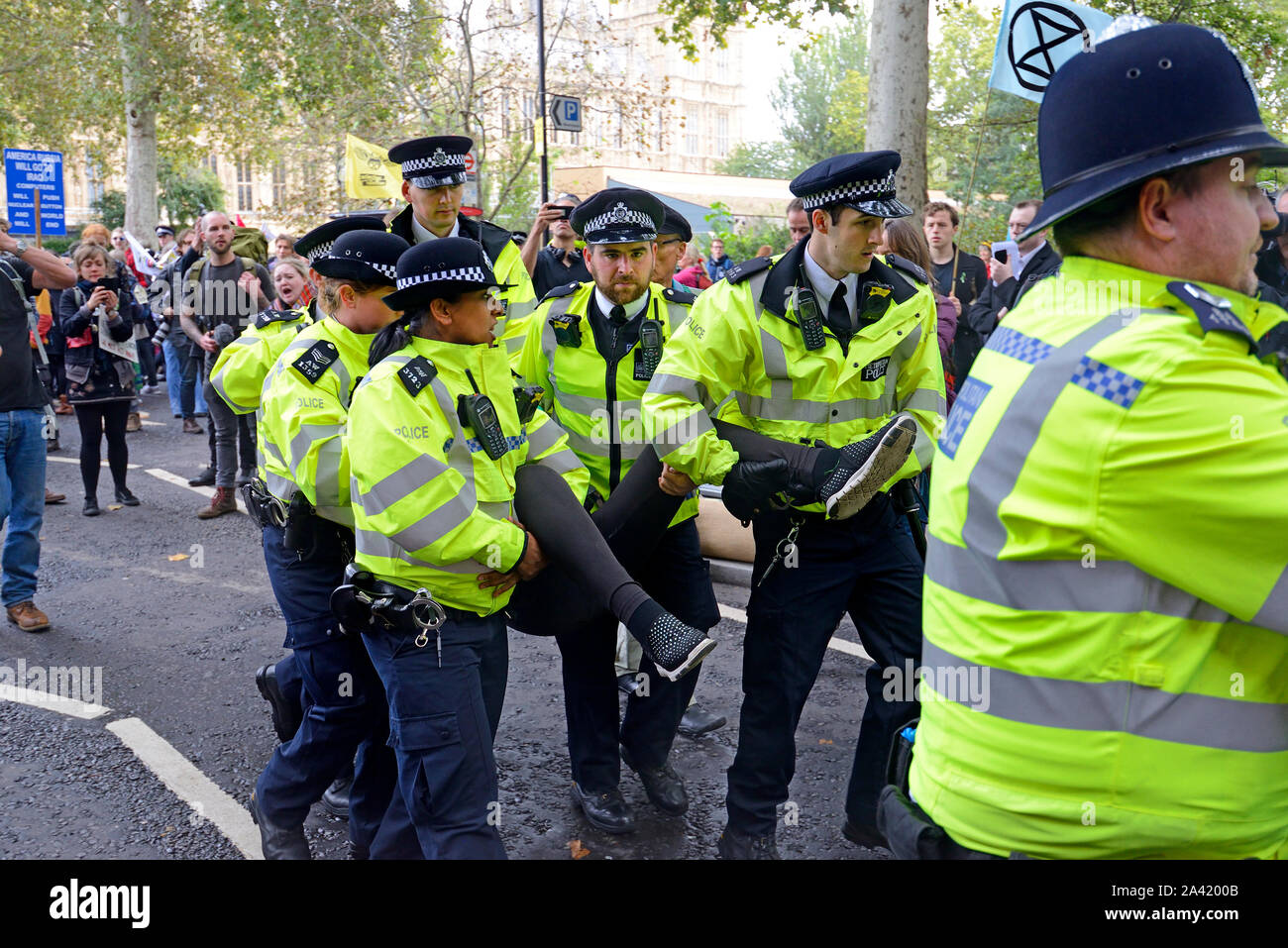 Londres, Royaume-Uni. Agents de la police métropolitaine de la dépose d'un manifestant lors d'une rébellion protester contre l'extinction à Westminster, Octobre 2019 Banque D'Images
