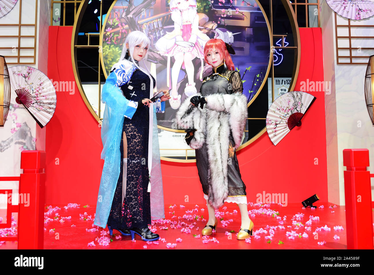 Showgirls chinois vêtus de costumes cosplay avec Monarch et Belfast de side-scrolling shoot 'em up jeu vidéo 'Azur Lane' poser pendant les 17 Banque D'Images