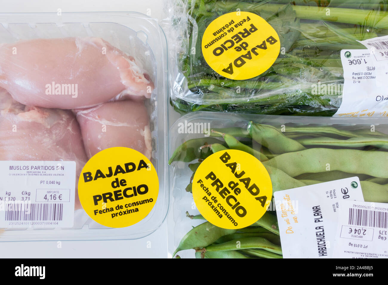 Cuisses de poulet et légumes emballés dans des emballages en plastique à prix réduit la vignette en supermarché de l'Espagne. Banque D'Images
