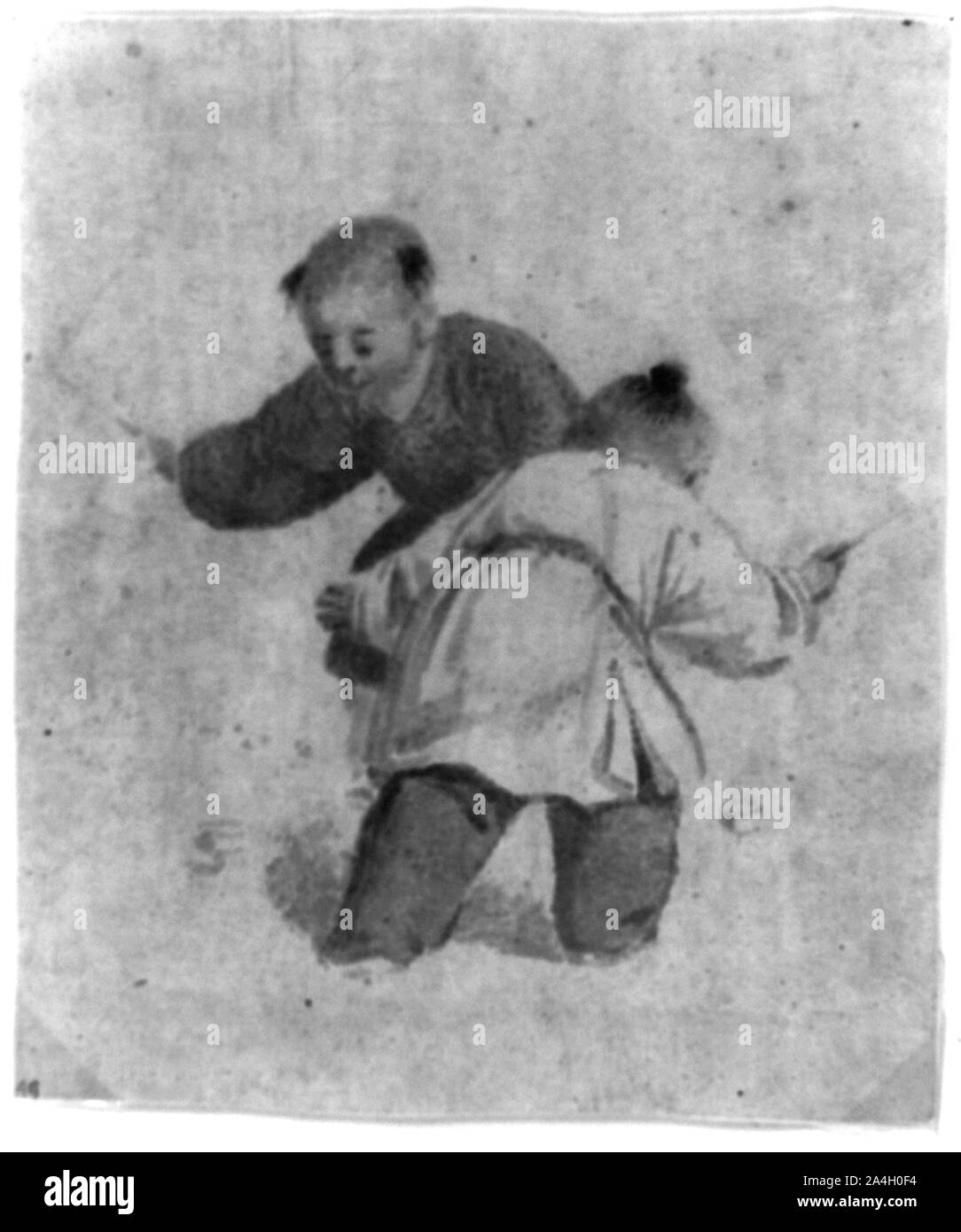 Deux garçons chinois jouant avec les toupies Banque D'Images