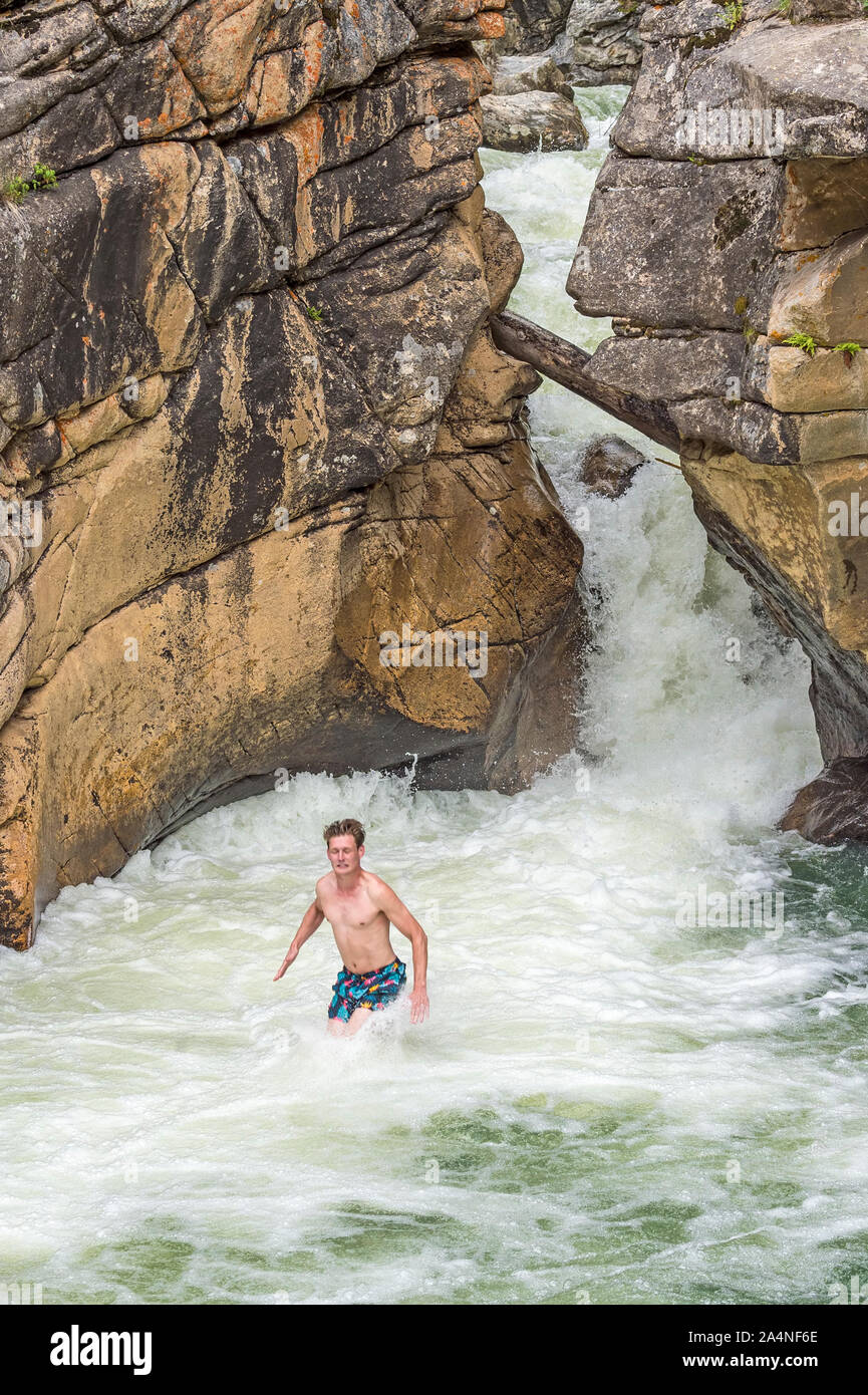 Un cavalier hits l'eau froide dans la rivière Roaring Fork comme il passe par les Devil's Punchbowl près d'Aspen, Colorado. Banque D'Images