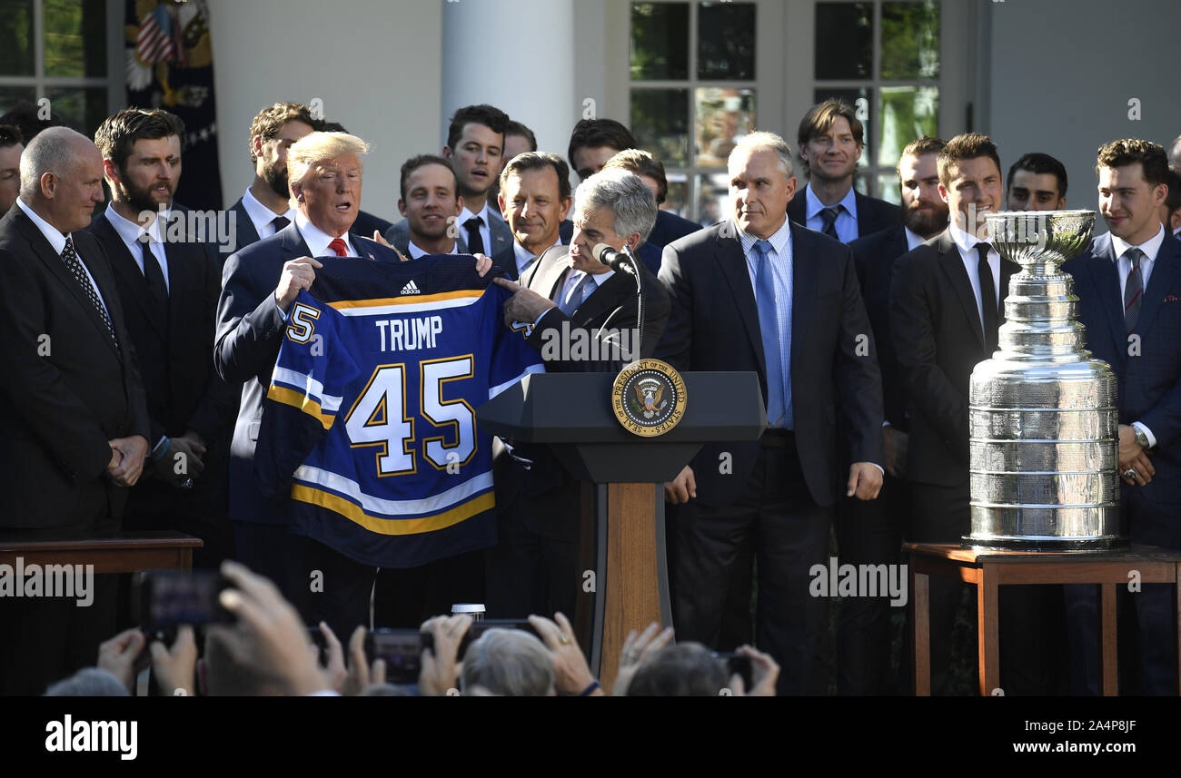 Washington, United States. 15 Oct, 2019. Le président Donald Trump nous tend un hockey présenté par des Blues de Saint-Louis de la Ligue nationale de hockey propriétaire principal Tom Stillman, en tant qu'entraîneur-chef Craig Berube regarde, dans la roseraie de la Maison Blanche, le mardi 15 octobre 2019, à Washington, DC. Les Bleus ont remporté leur première Coupe Stanley (R) La saison dernière. Photo de Mike Theiler/UPI UPI : Crédit/Alamy Live News Banque D'Images