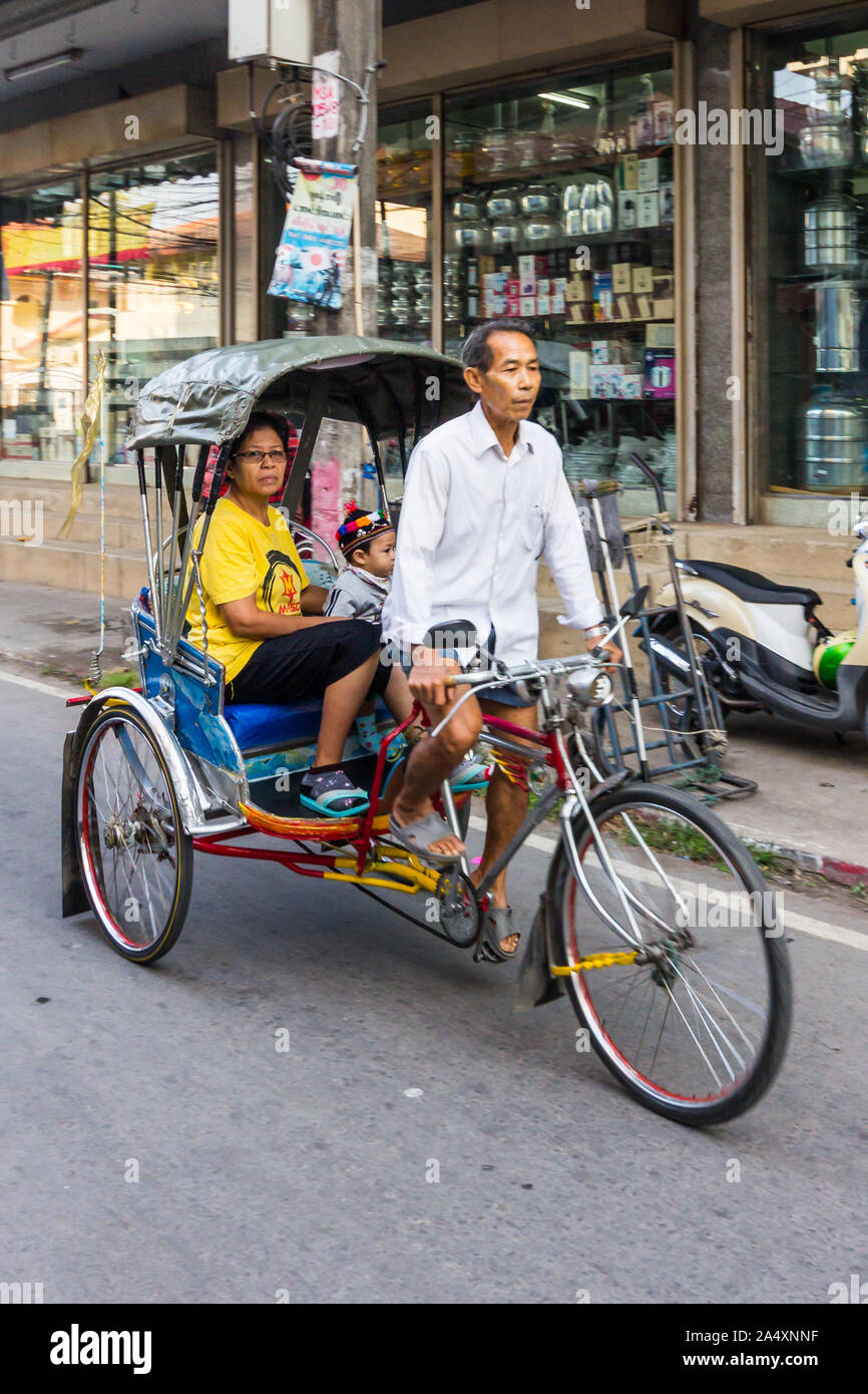 Mae Sot, Thaïlande - 3 Février 2019 : Femme et enfant voyageant dans un cyclo. Cette forme de transport est en train de mourir. Banque D'Images
