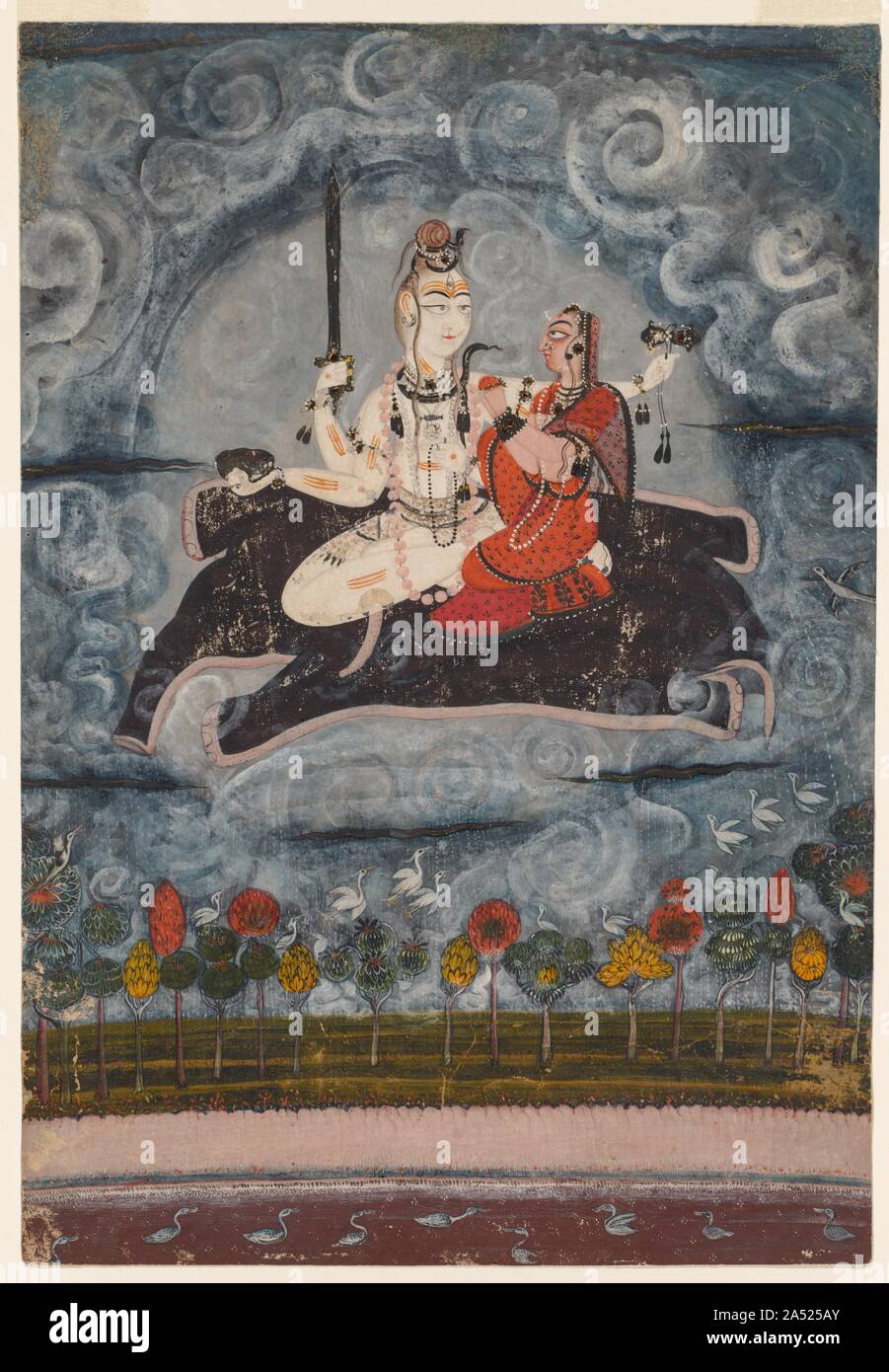 Shiva et Devi sur la peau de Gajasura, ch. 1675-1680. Ces amoureux divin incarnent la dualité des opposés : homme/femme, yogi/Princess, la mort et la destruction, la naissance//création. Leurs regards sont fixés sur l'autre, en les reliant à l'unité d'amour qu'elles flottent sur la peau d'un démon de l'éléphant à travers les nuages de mousson tourbillonnant au-dessus de la terre. Le dieu Shiva ressemble à un yogi avec mèches de cheveux nattés serpents entrelacés avec la peau blanche, enduit de cendres provenant des grands bûchers, le troisième oeil de la vraie connaissance, triple-line marques sectaire, une guirlande de têtes coupées, et la peau de léopard-pagne. En trois part Banque D'Images