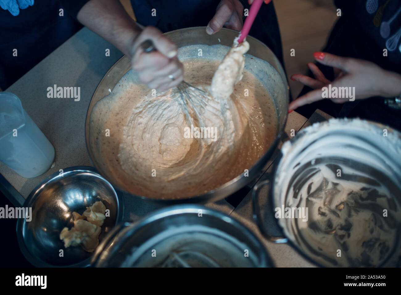 Remue la main blanche, pâte, sauce ou dessert dans un bol Banque D'Images