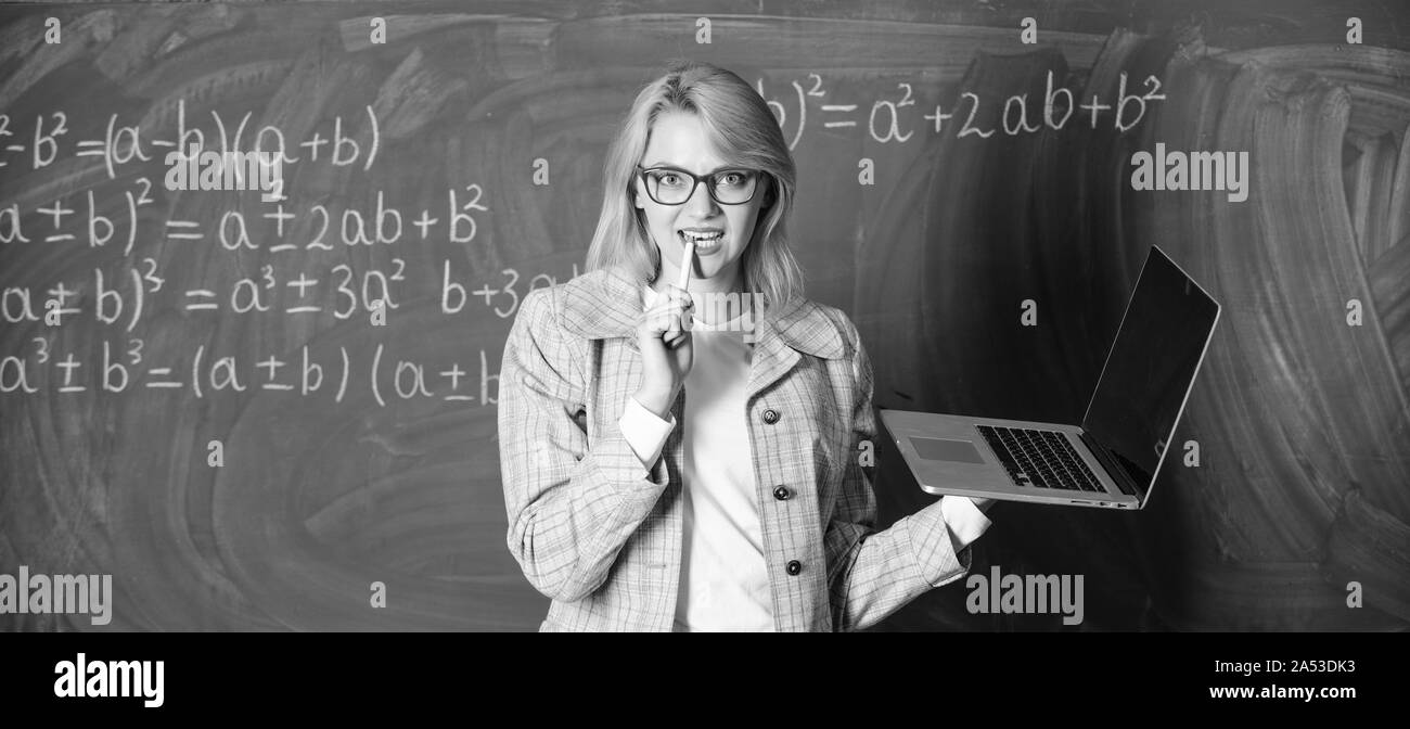 Dame intelligente smart éducateur avec ordinateur portable moderne tableau internet surf arrière-plan. Les technologies numériques concept. Idée sur son esprit. Enseignante portent des lunettes est titulaire d'ordinateur portable Internet surf. Banque D'Images