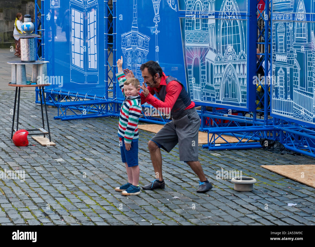 Jeune garçon dans le public prenant part à la rue. Edinburgh Fringe Festival. Royal Mile, Ecosse Banque D'Images