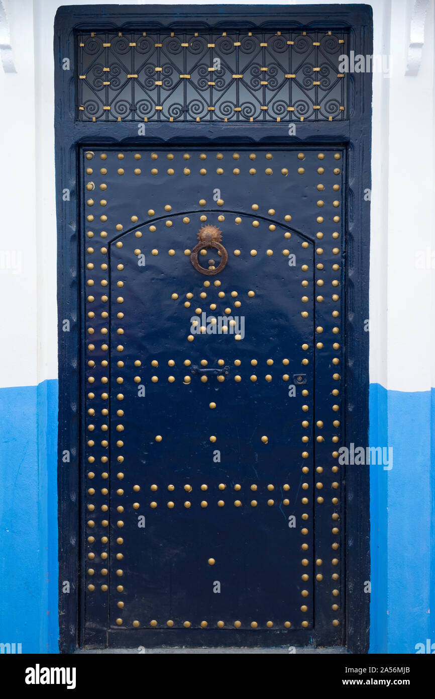 Porte en bois peint en bleu avec décoration de couleur or dans la médina d'Asilah, Maroc Banque D'Images