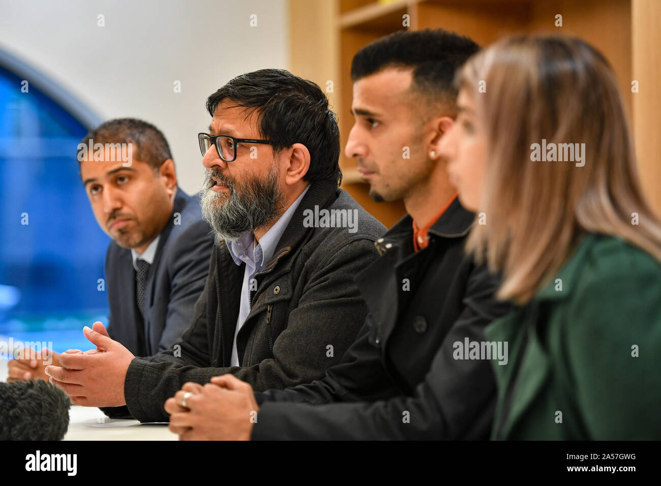 Amir Ahmed, membre du groupe de protestation (2e gauche), s'entretient lors d'une conférence de presse dans le centre de Birmingham après qu'un juge ait réservé sa décision sur une demande de maintien d'une zone d'exclusion de protestation autour de l'école primaire Anderton Park de Birmingham. Banque D'Images