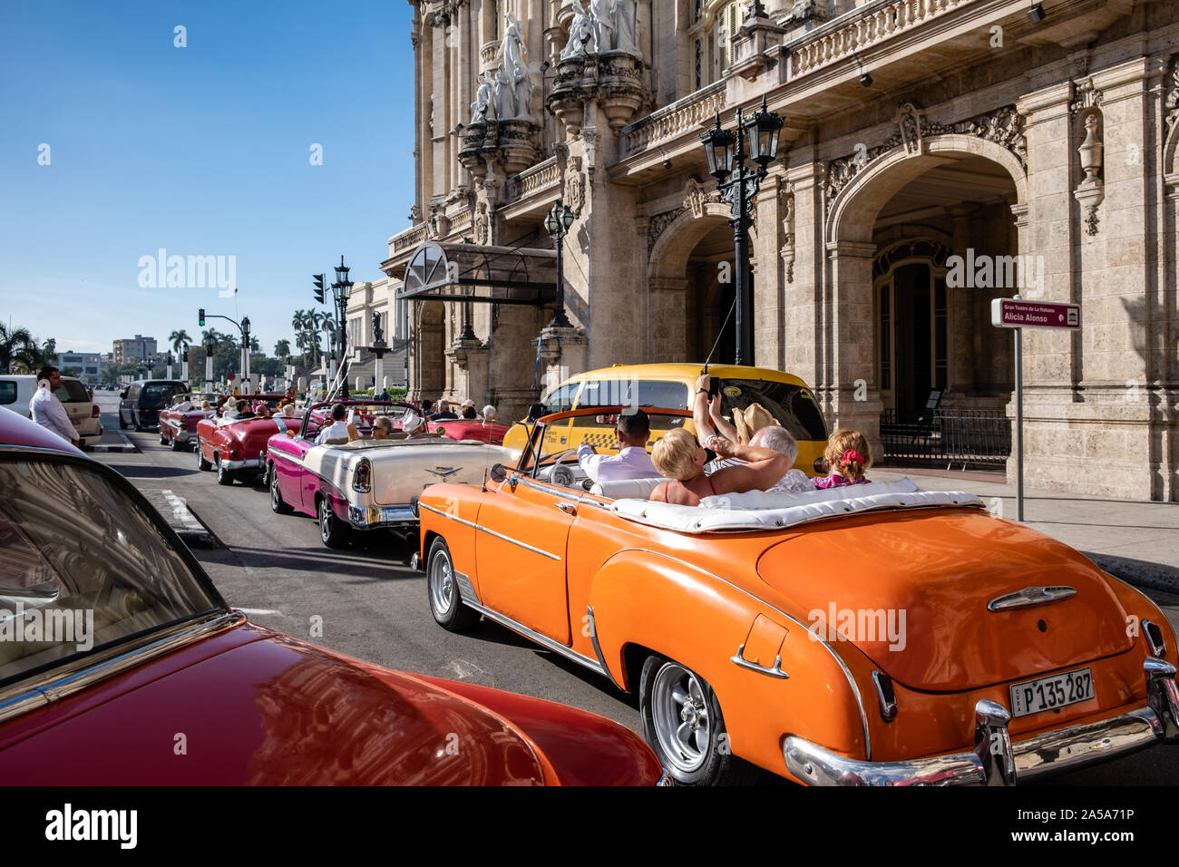 Scène de rue avec Vintage Classic American Taxi voitures transportant les touristes, La Havane, Cuba Banque D'Images