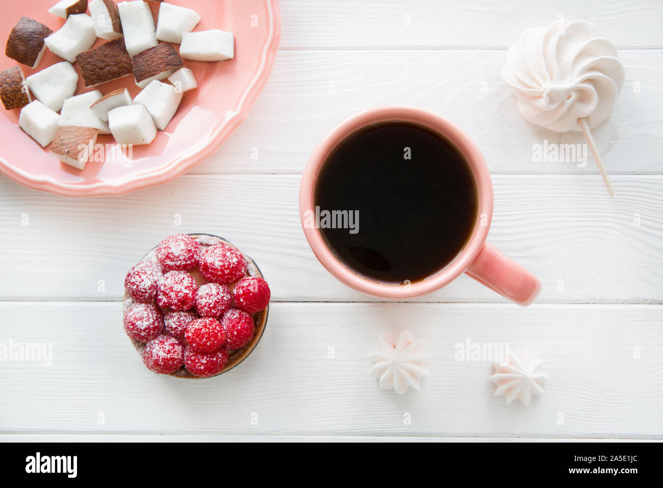 Collation santé et du café noir dans les récifs de tasse sur la table en bois blanc, vue du dessus. Banque D'Images